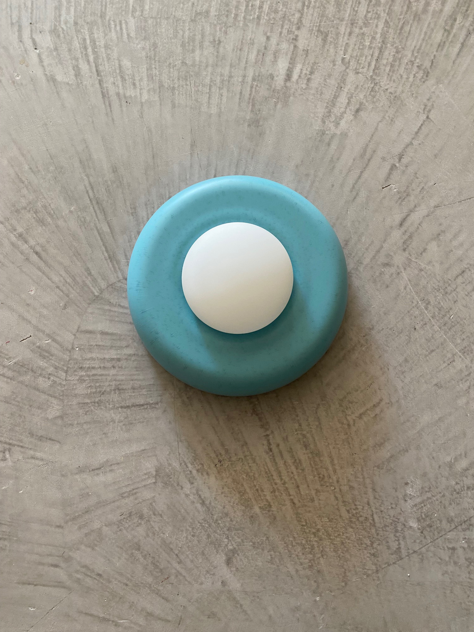 ChromaBlock Wall Sconces in red, green, yellow and blue on a marble table