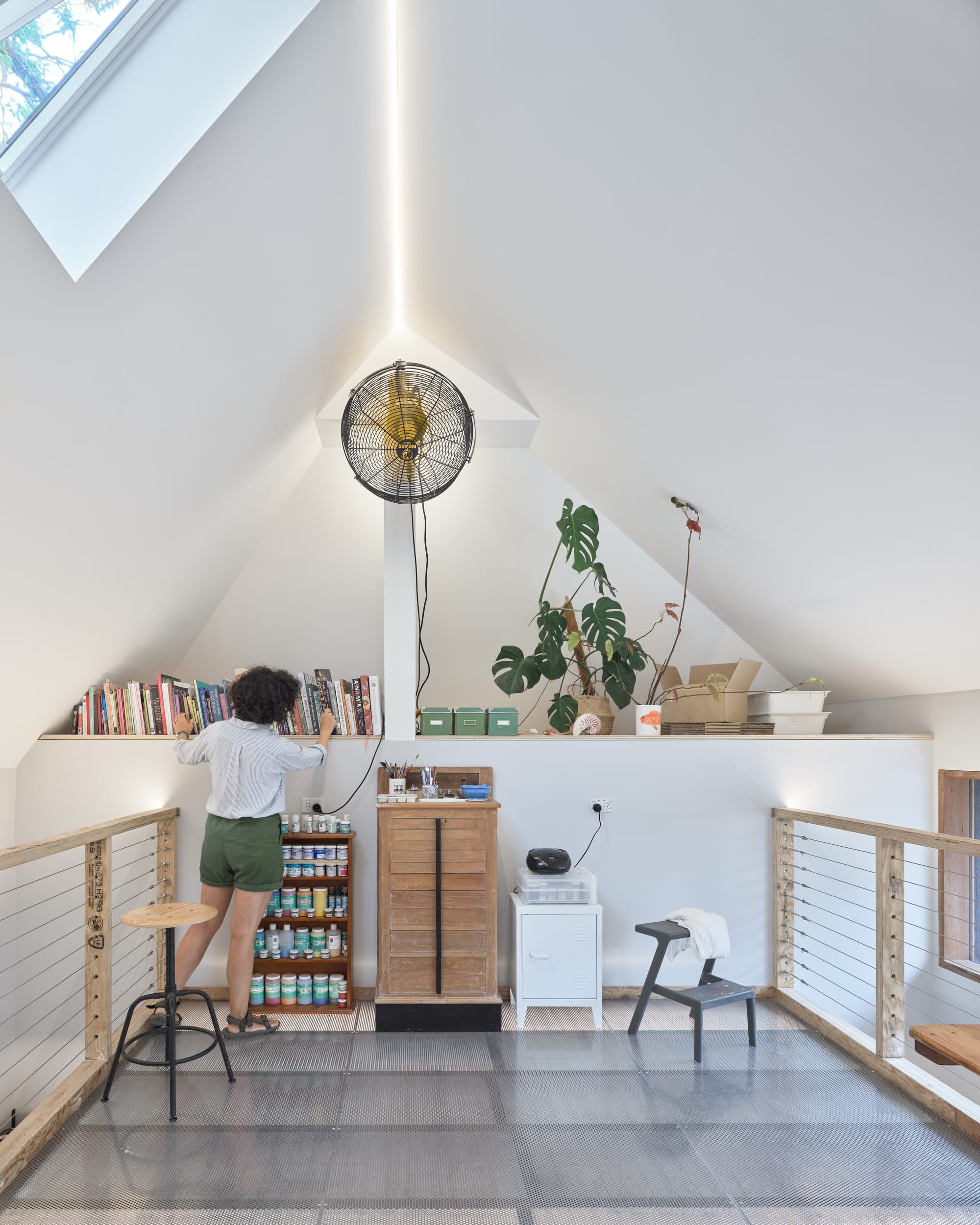 Coconut Crab by Alexander Symes Architect. Photography by Barton Taylor Photography. Loft with perforated floor and high cathedral ceilings. Integrated wall shelf along back wall.