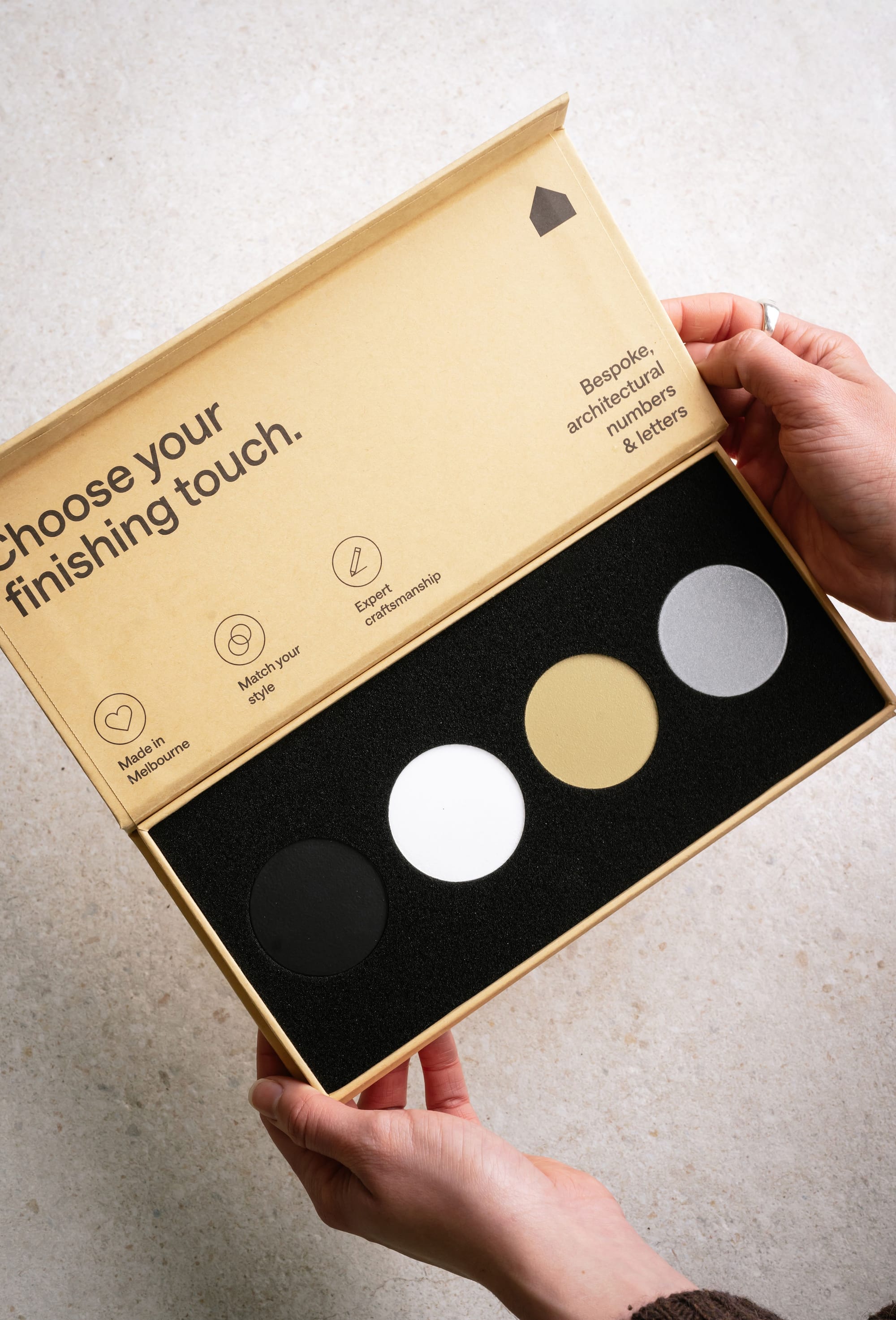 Peninsula House Numbers. Image copyright of Peninsula House Numbers. Gold selection box of four metal colours in circles. Black, gold, silver and white.