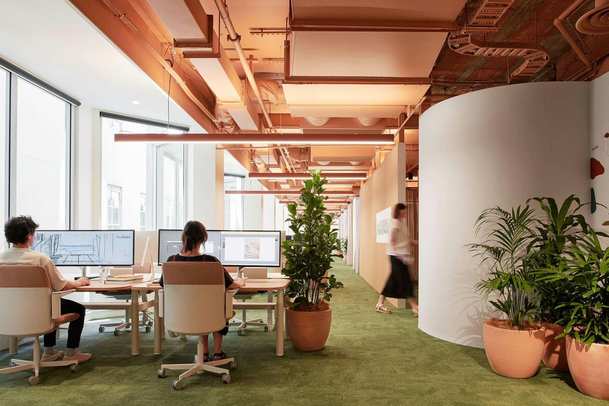 Hames Sharlaey Melbourne Studio by Hames Sharley. Office view with big windows, green carpet and industrial ceiling.