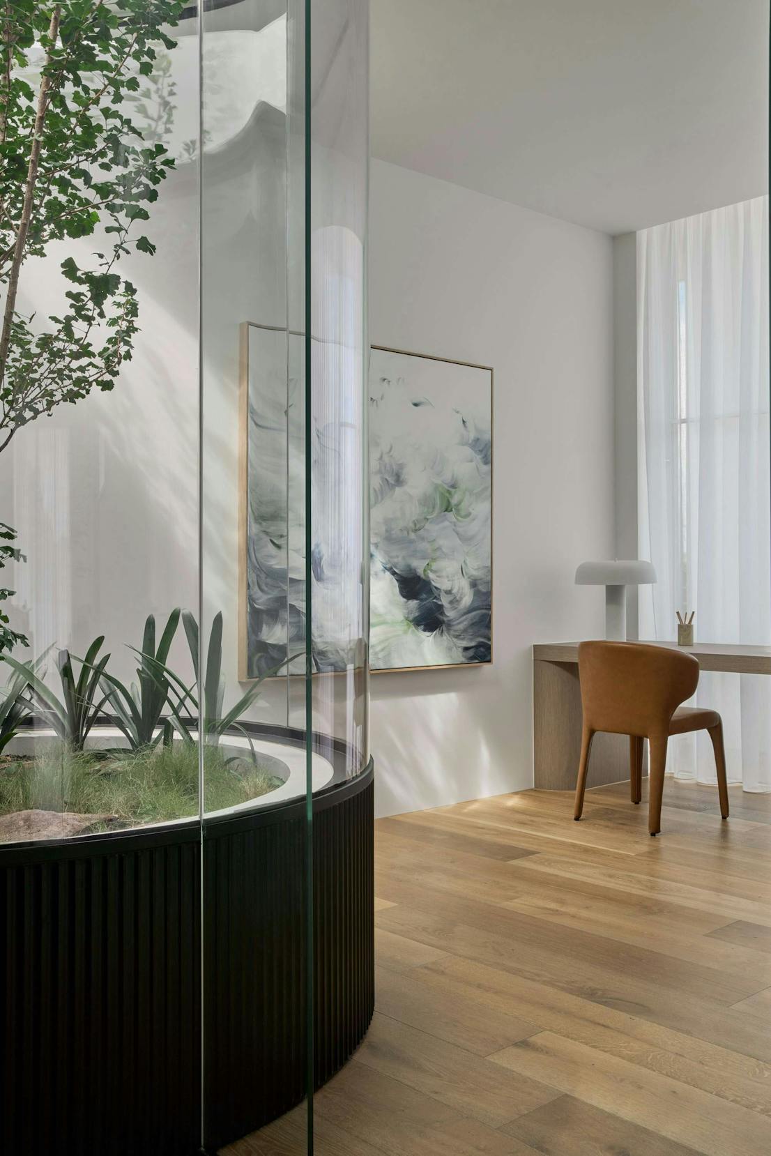 Brighton Apartments by Merrylees Architects. Atrium featuring tree with view to office space.