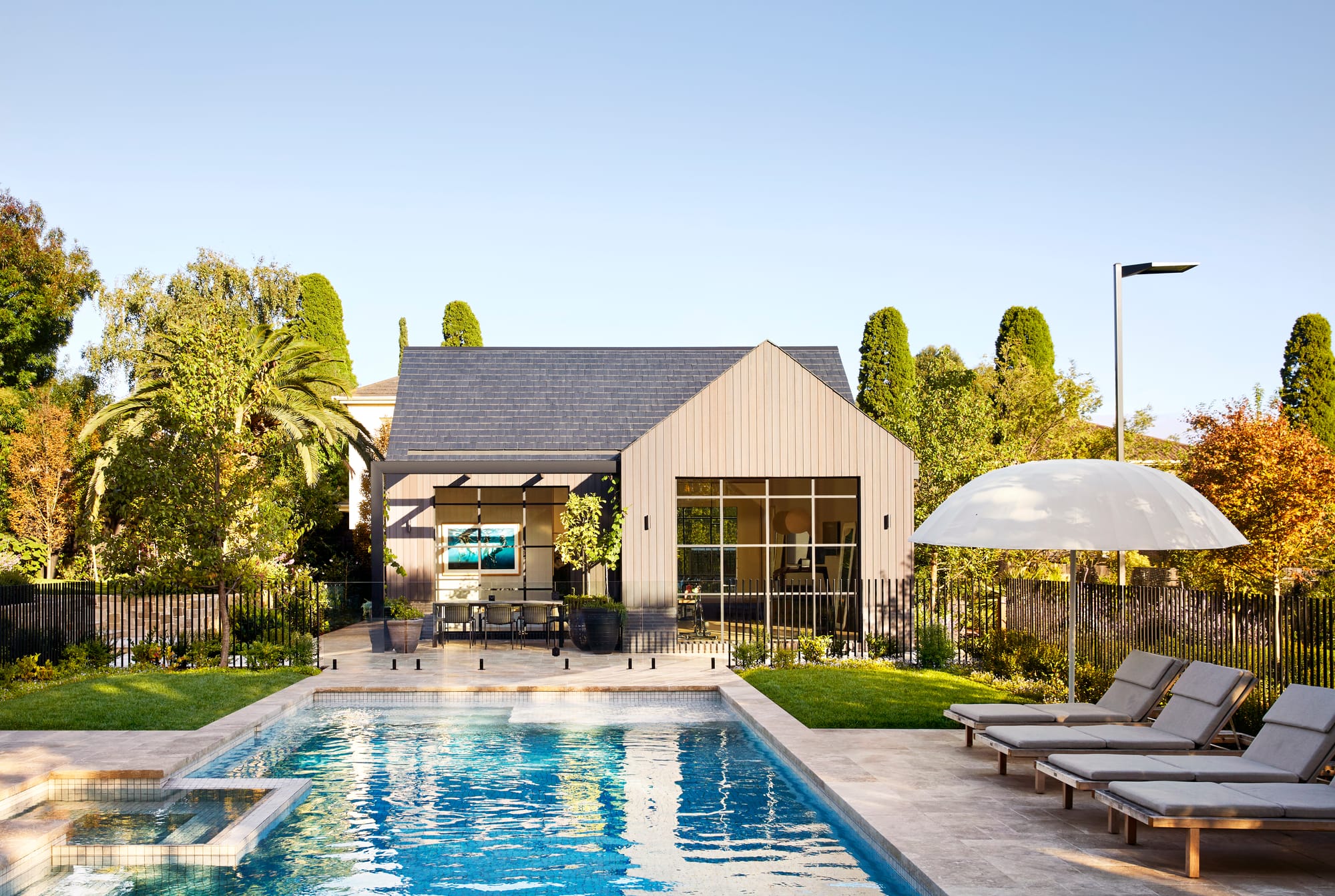 Armytage House by Myles Baldwin Design. Private pool area with view to modern architectural extension sourrunded by greenery.