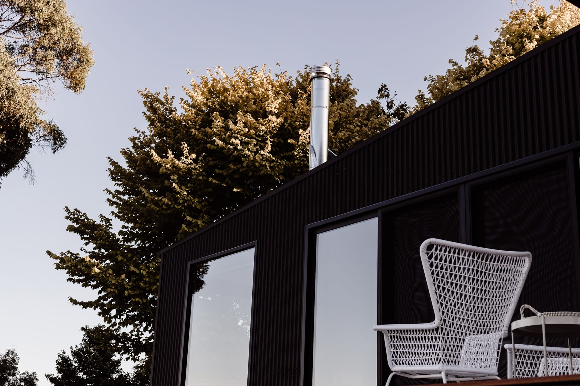 Roam Escape by Roam Merrijing. Luxury accommodation view featuring black corrugated sheet facade.