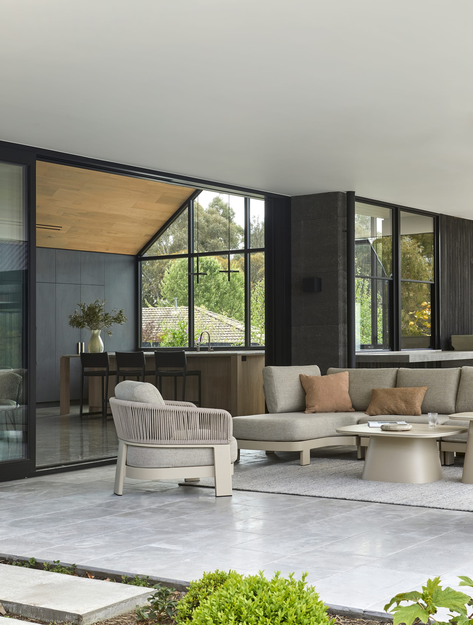 Valencia Rope Modular Sofa & 1 Seater Sofa by GlobeWest. Loggia with view to kitchen, lounge chair, sofa and coffee table featuring sand tones.