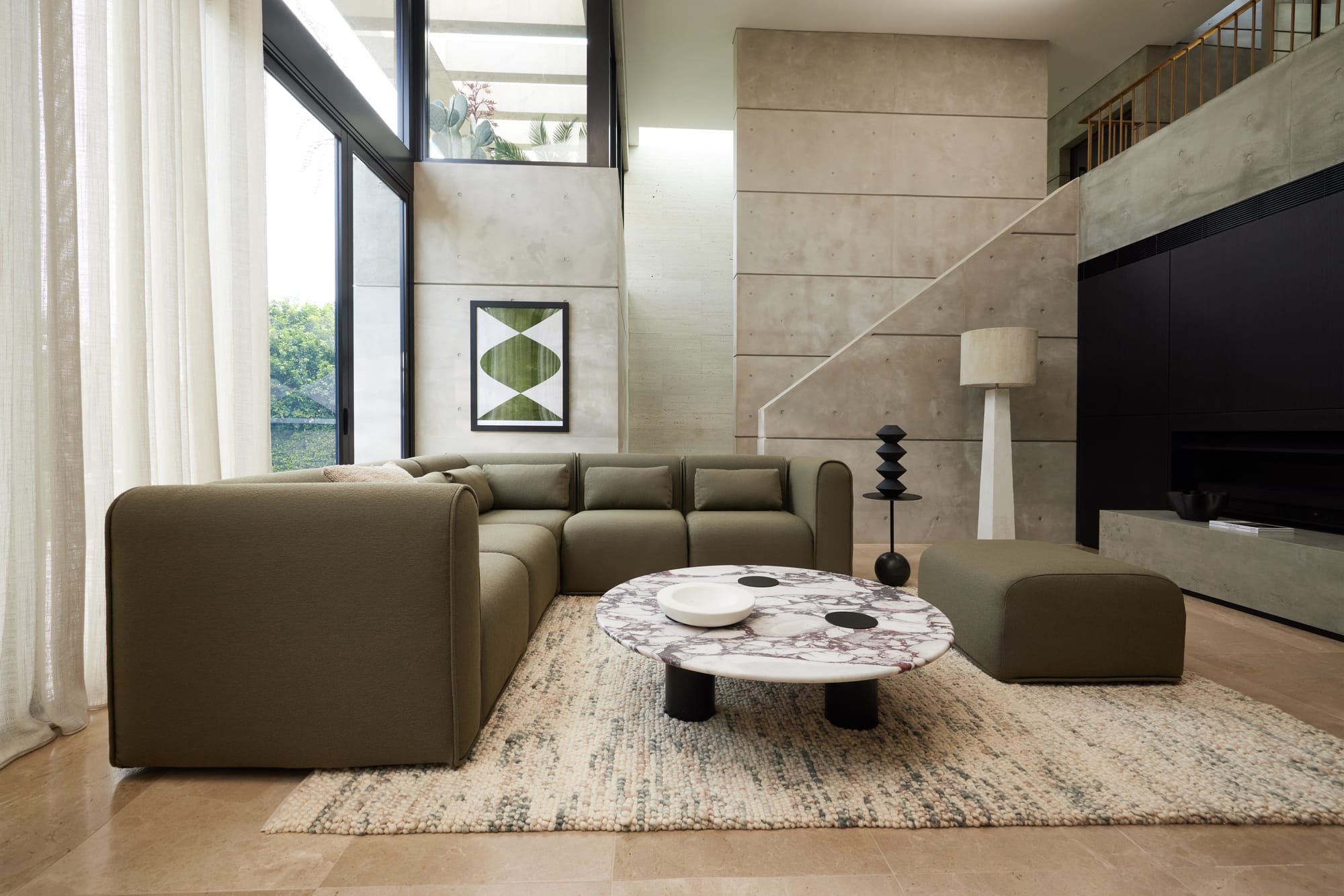 Bangalow Modular Sofa in Wattle Green. Green boucle sofa in double story residential space with marble coffee table and tiled floors. 