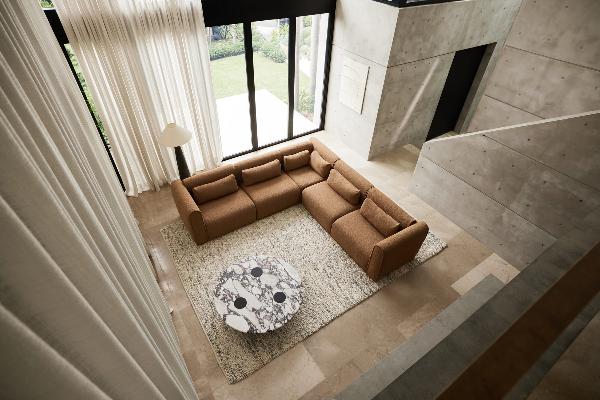 Bangalow Modular Sofa in Sand Dune. Tan boucle couch in L-arrangement with marble coffee table in tiled residential living space. 