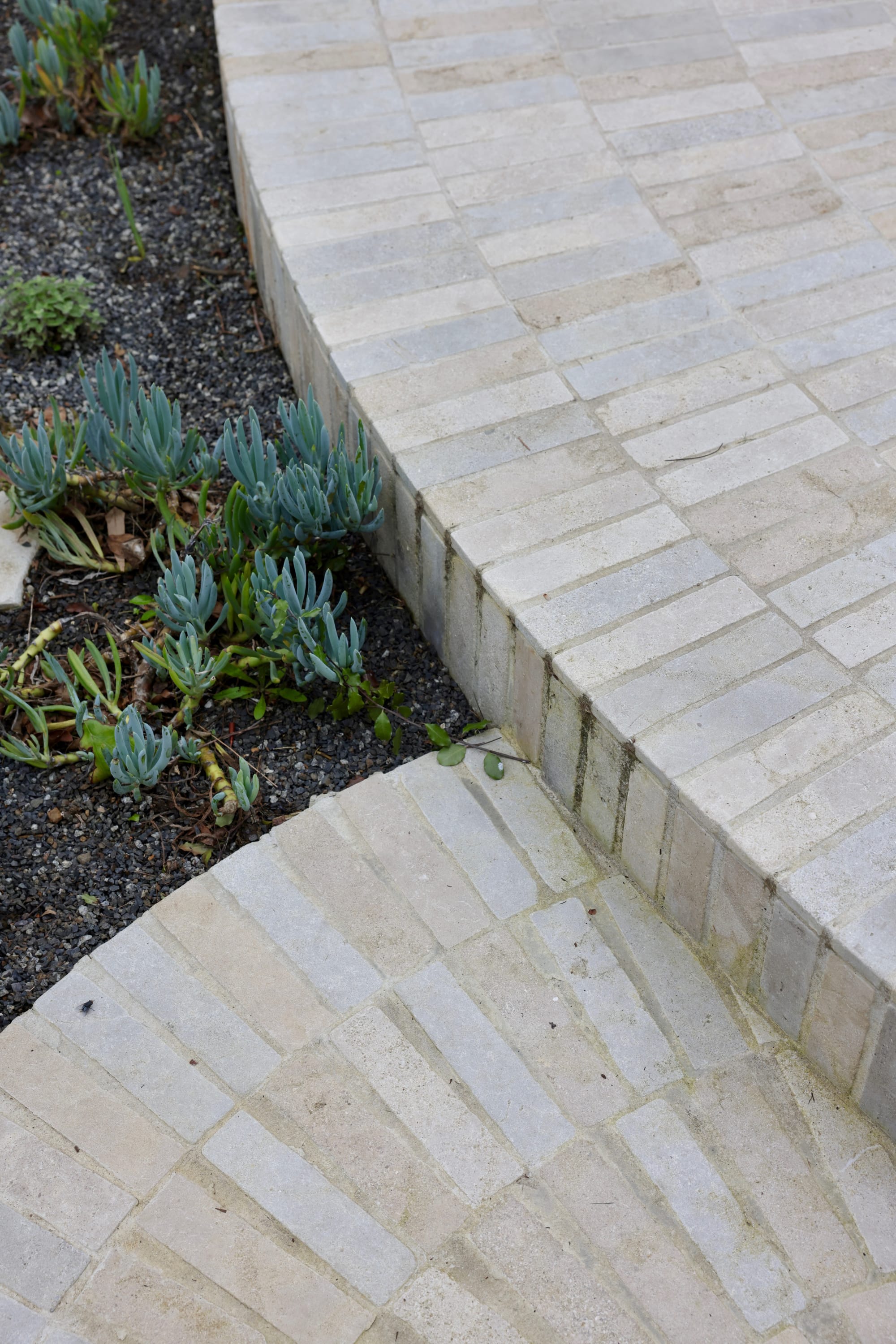 Glen Iris by Julie Crowe Landscape Design x Cosh Living. Photography by&nbsp;Eloise Sim. Overhead shot of grey limestone pavers in radial arrangement in outdoor garden. 
