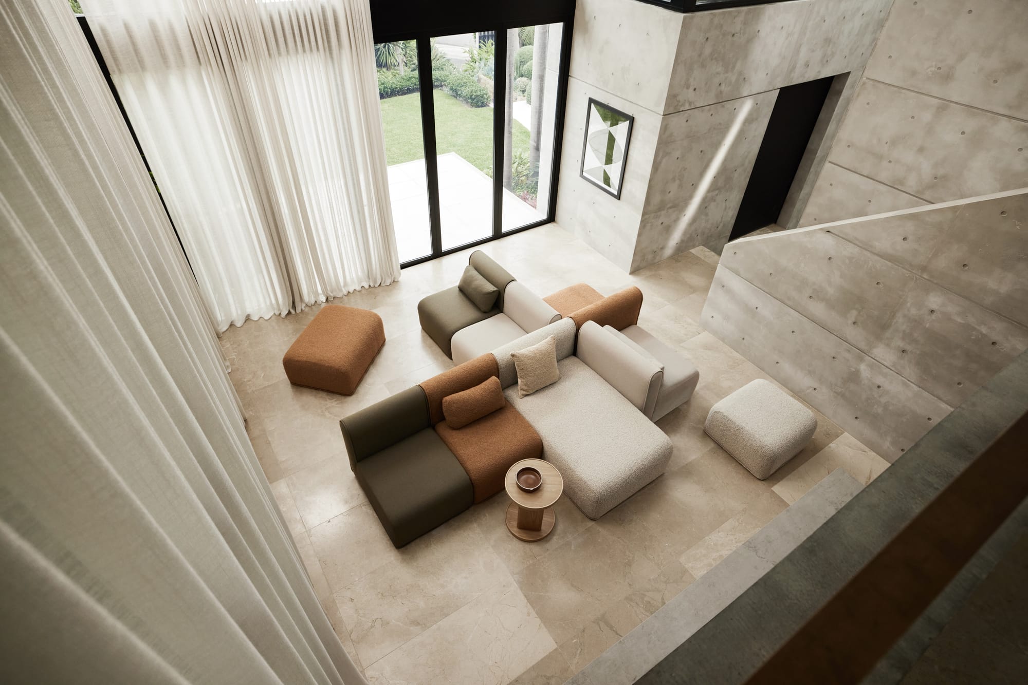 Bangalow Modular Sofa. Aerial view of an arrangement of modular lounges on a tiled residential space, in green, tan and beige. 