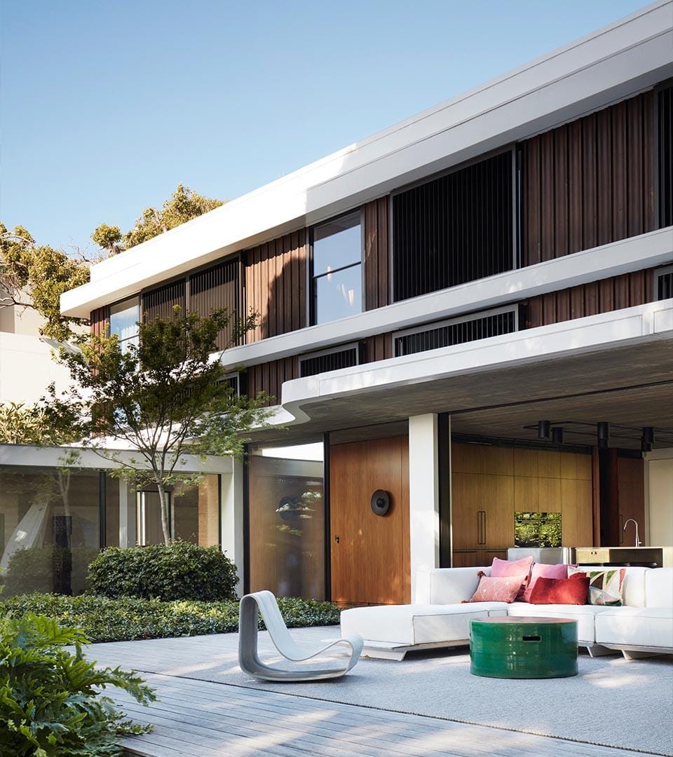 Showing the exterior of Casa Figueria by buckandsimple with a nice courtyard and house in the background.