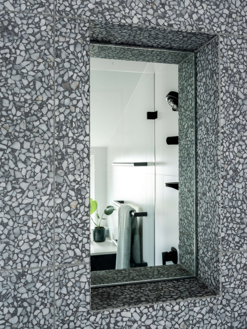 Cross Cut House by BIJL Architecture. Photography by Tom Ferguson. Recessed mirror in shower surrounded by grey speckled granite wall tile. 