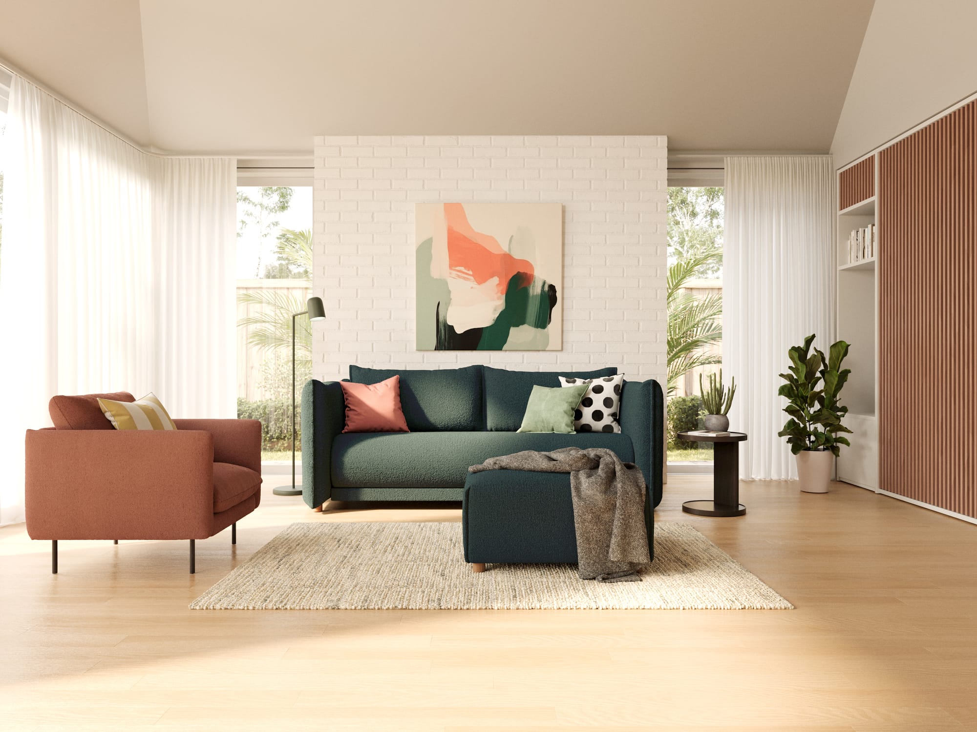 Byron Sofa Bed in Aussie Moss by Koala. Dark green sofa in a living space with white brick walls, timber floors, white sheer curtains and a terracotta armchair. 