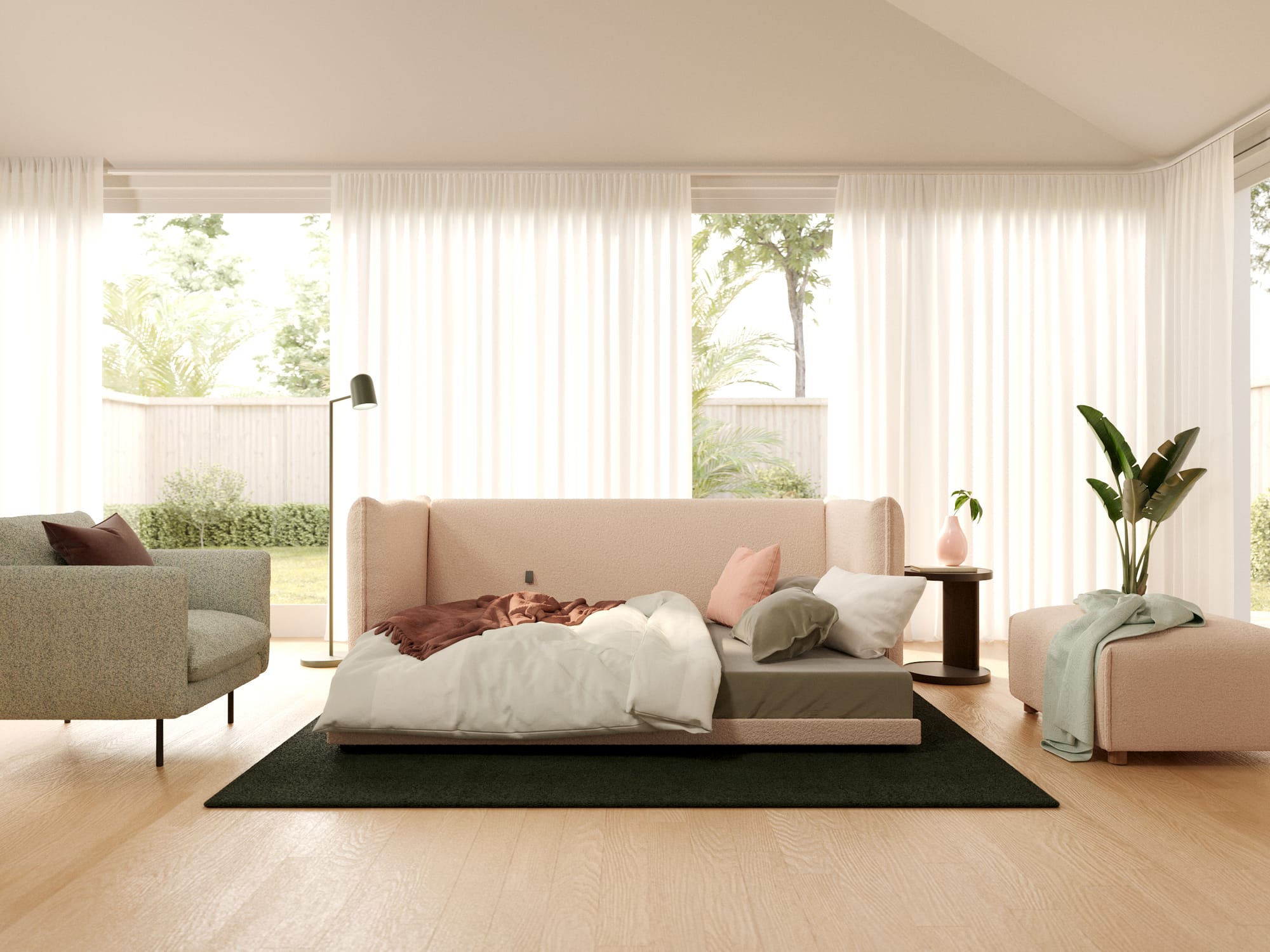 Byron Sofa Bed in Sand Bank by Koala. Living room with pale pink sofa bed couch, grey arm chair and pink footstool, with dark rug and timber floorings.