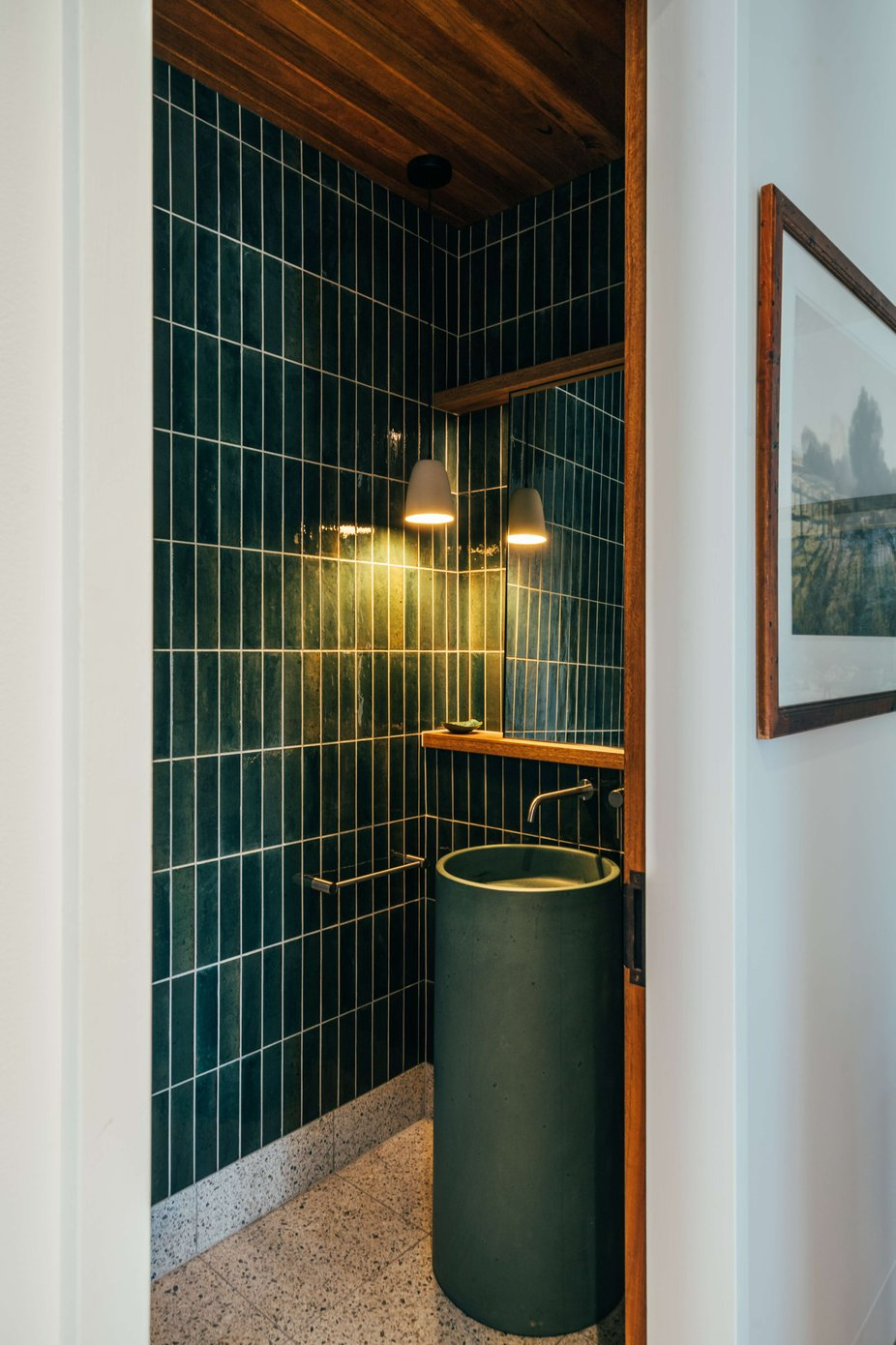 Project 465 by Robertson Collectif. Photography by Anna Mul. Toilet with moss green wall tiles, freestanding green stone sink and timber details. 