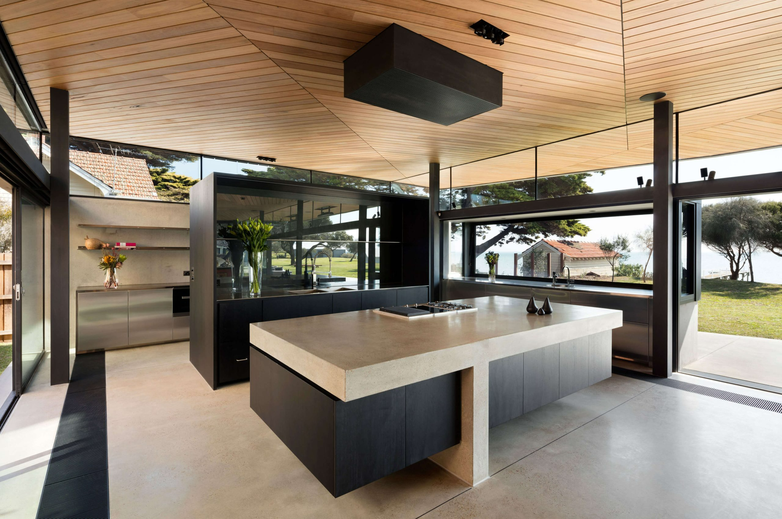 Sorrento Beach House by AM Architecture. Photography by Dianna Snape. Open plan kitchen with large island benchtop, large scullery and open plan layout.