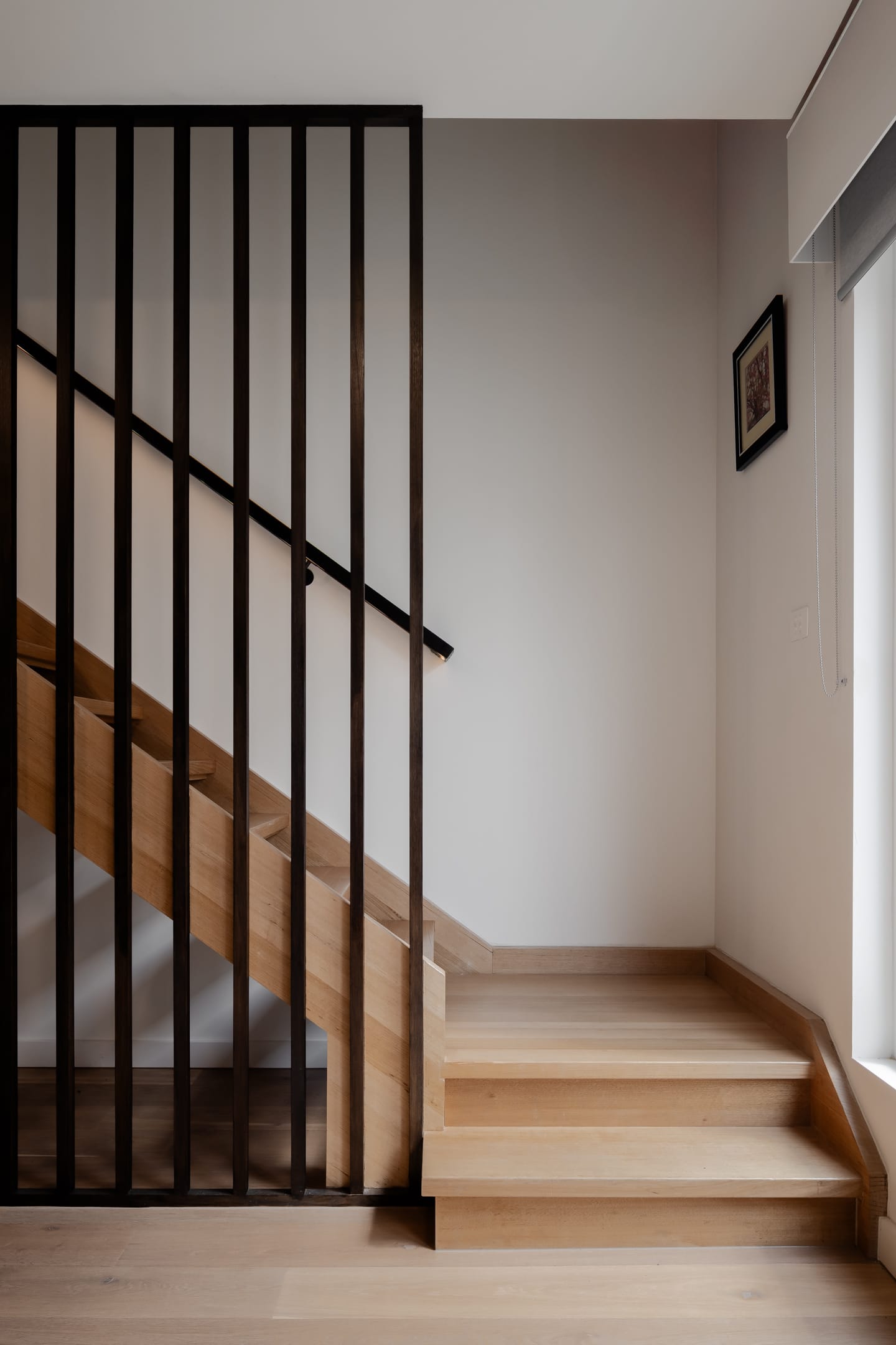TREE HOUSE by R Architecture. Photography by CM Photography. Wooden staircase with metal support with a frame hanged on the wall.