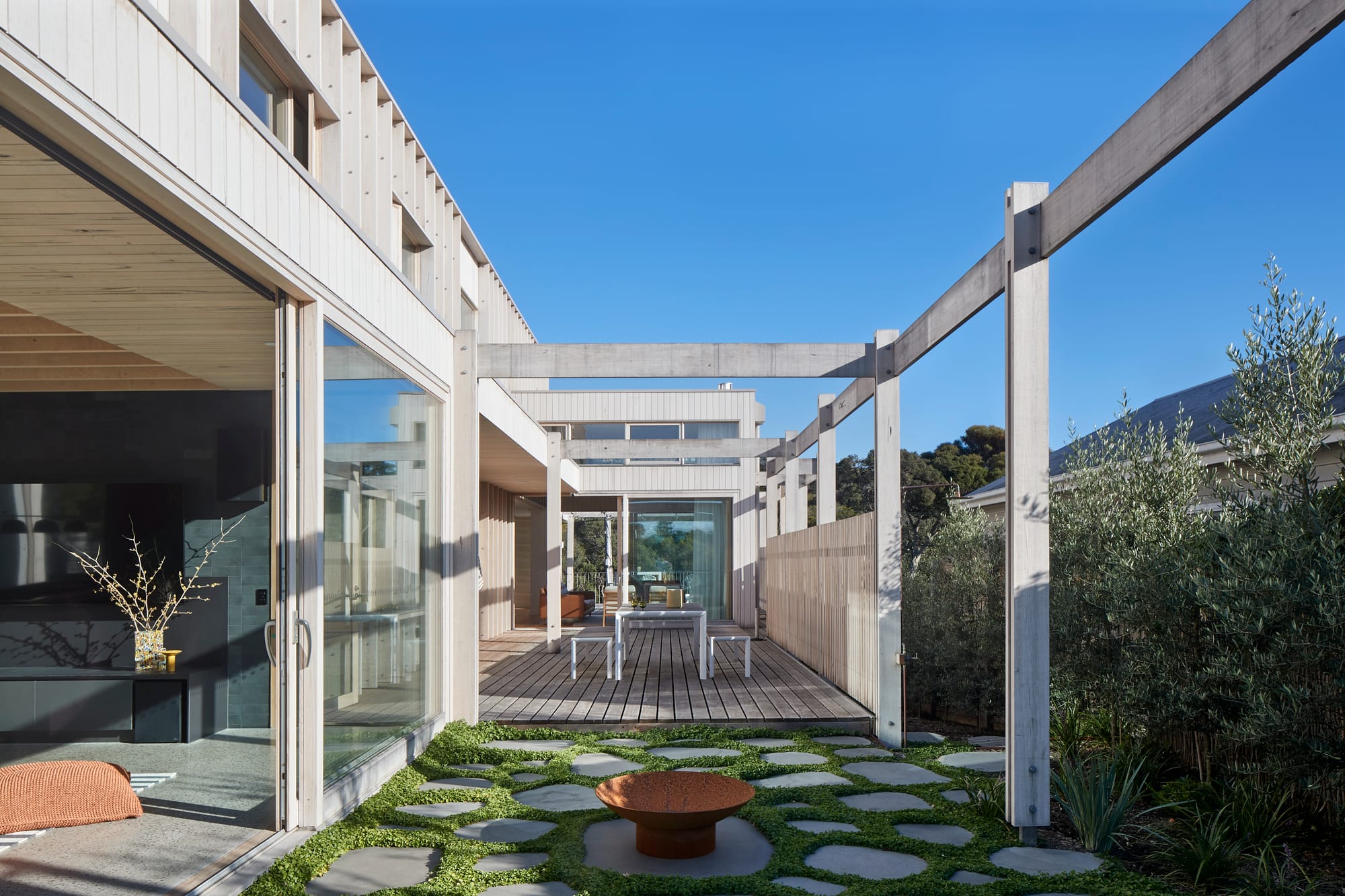The Blairgowrie Beach Club by Bower Architecture & Interiors. Photography by Shannon McGrath. Outdoor wooden patio with stone paved space.