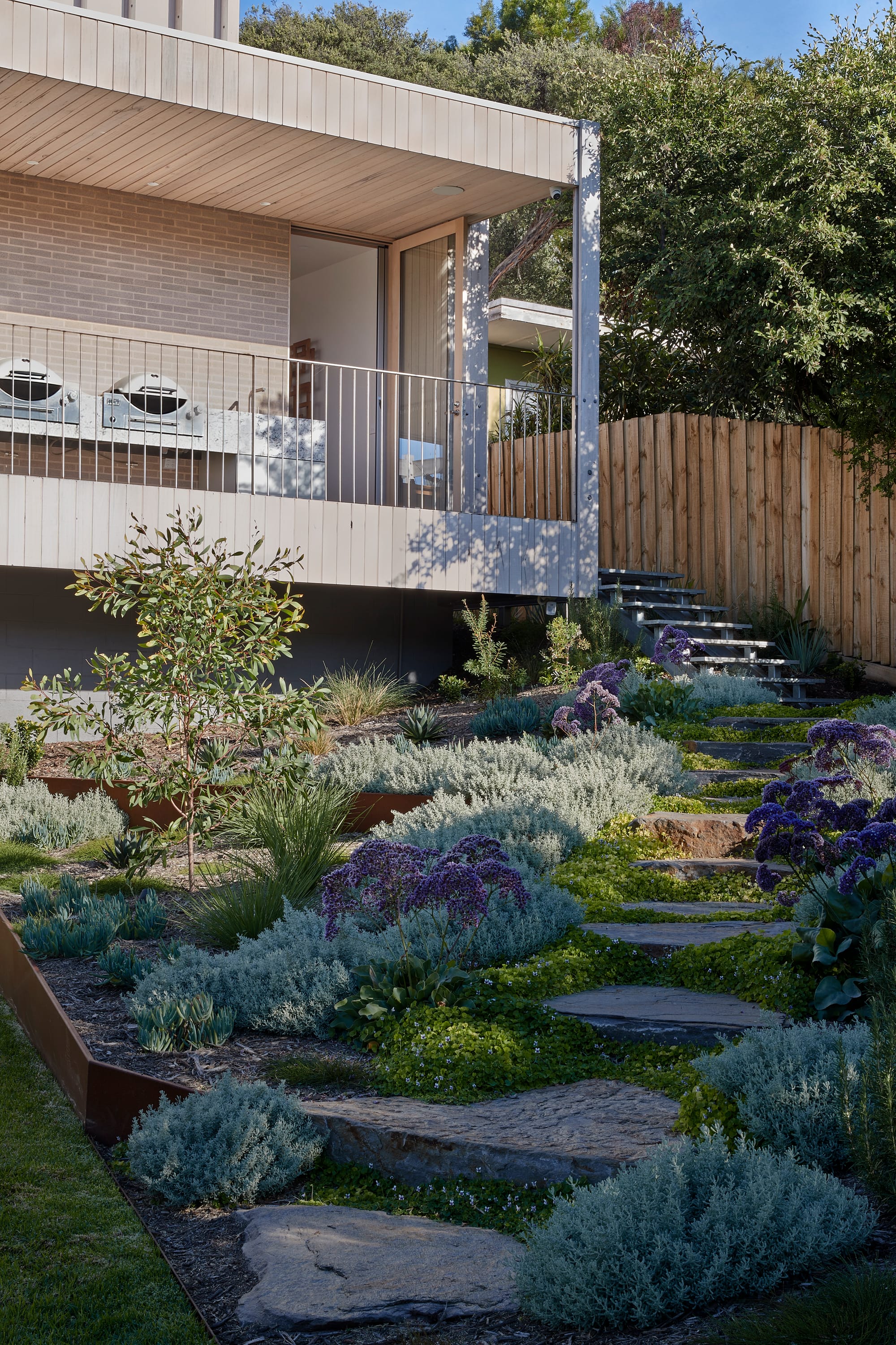 The Blairgowrie Beach Club by Bower Architecture & Interiors. Photography by Shannon McGrath. Corridor with wooden floor with painting hung against the wall.