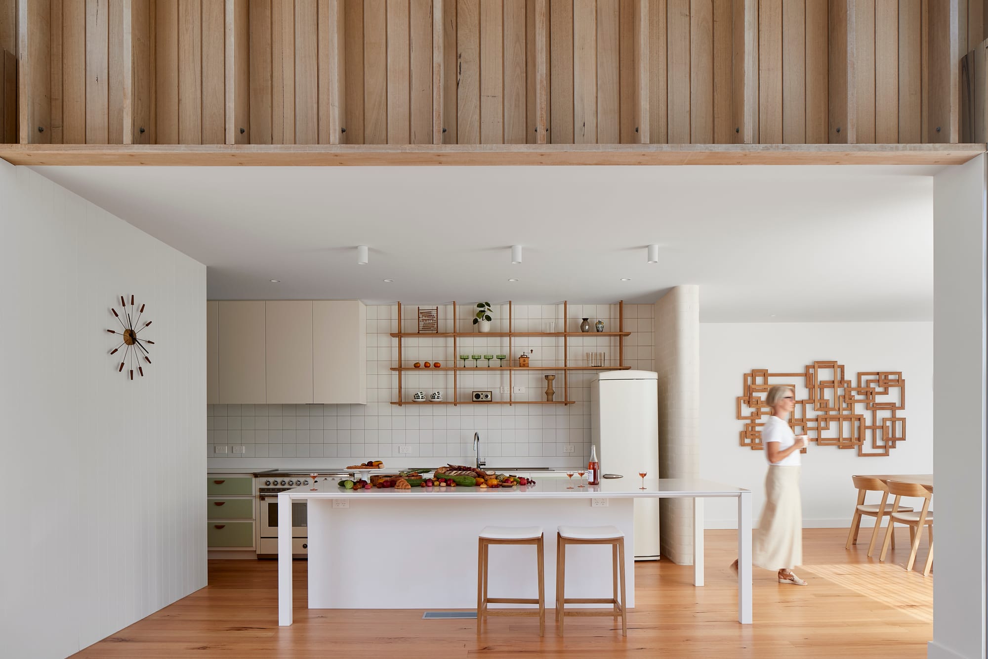 The Blairgowrie Beach Club by Bower Architecture & Interiors. Photography by Shannon McGrath. A beautiful white toned kitchen with wood flooring.