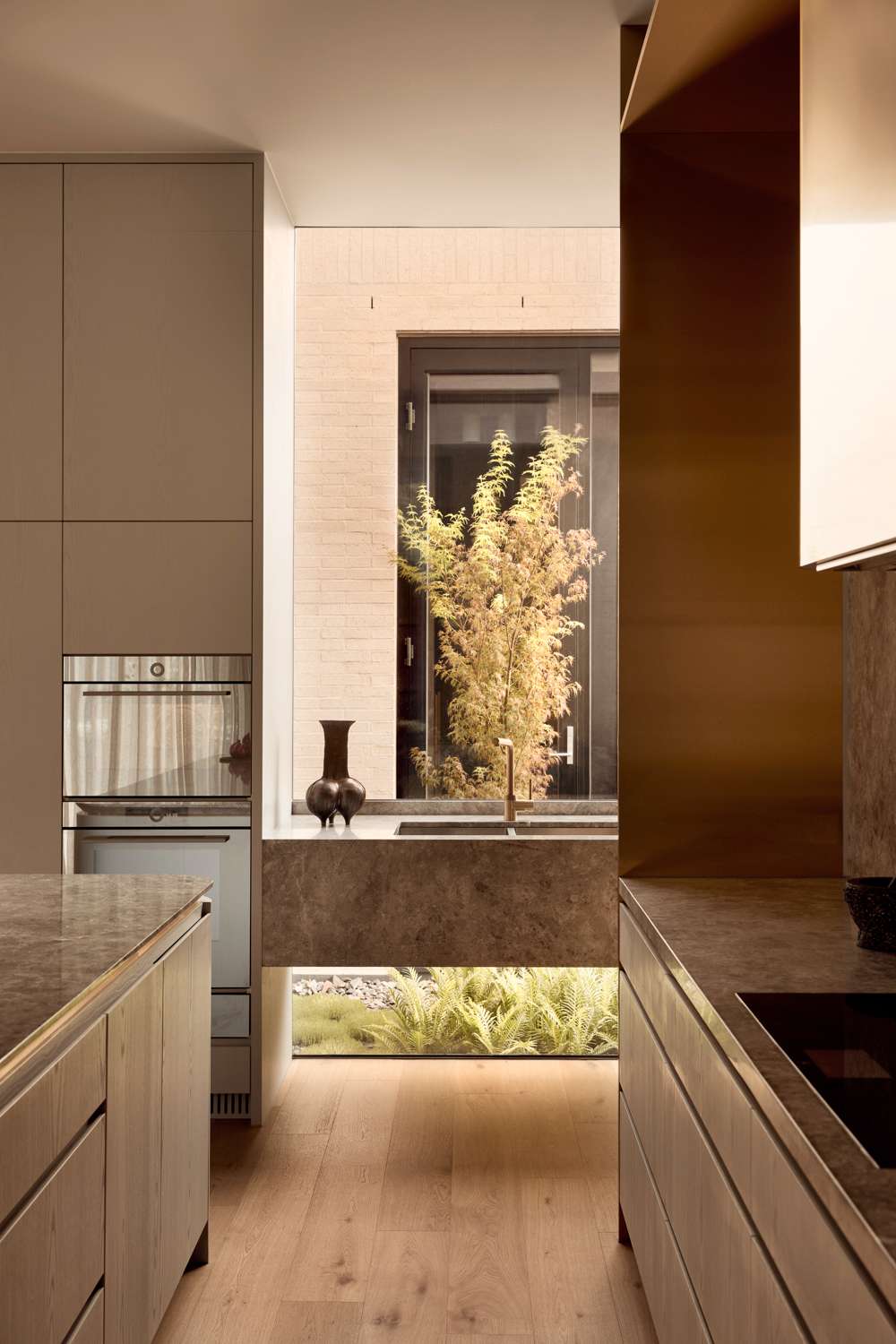 Brixton by Cera Stribley. Photography by Martina Gemmola. Full height window view from inside viewing courtyard outside.