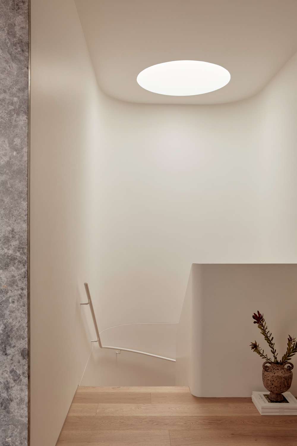 Brixton by Cera Stribley. Photography by Martina Gemmola. Skylight above the staircase with white painted wall with railing.