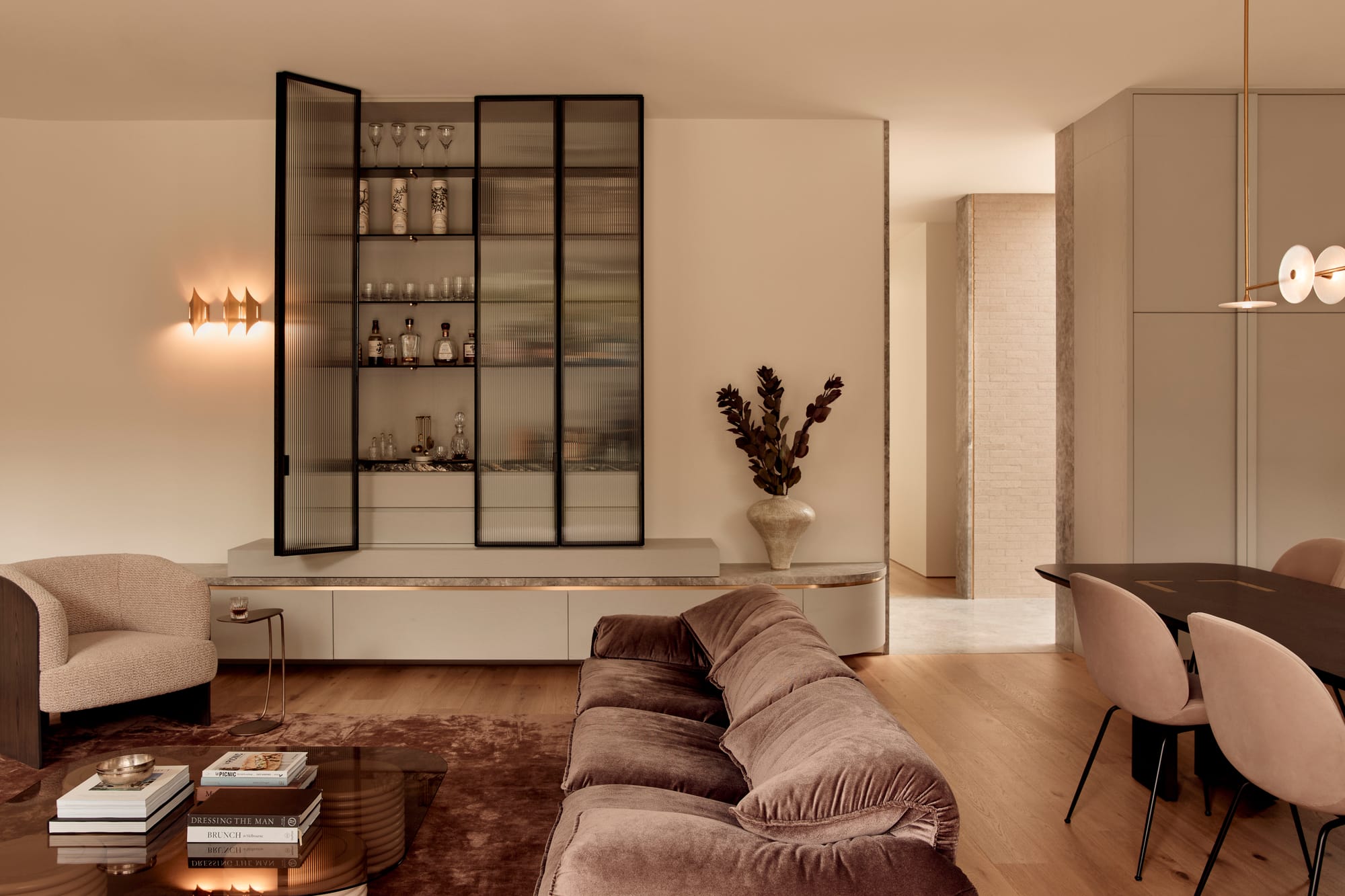 Brixton by Cera Stribley. Photography by Martina Gemmola. Living room with inbuilt cabinet in the wall with brown toned furnitures.