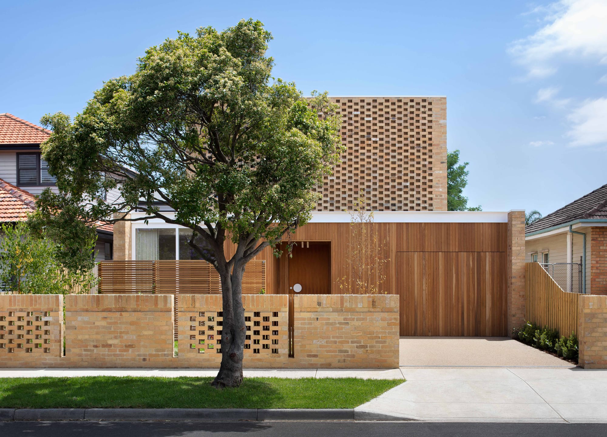 Haka House by Taouk Architects showing the exterior street facade of red and brown brick and timber.
