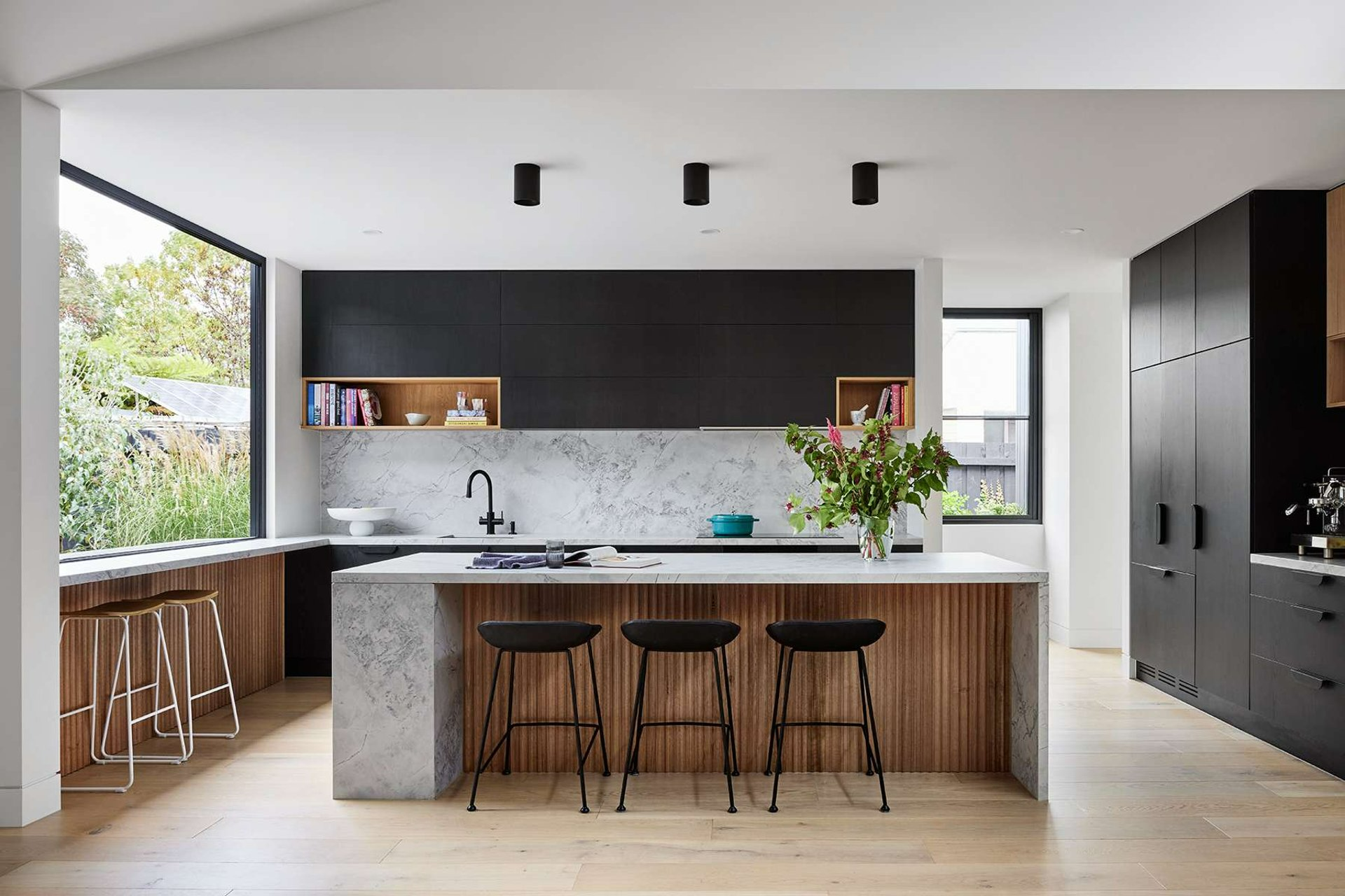 Long Street by Keen Architecture. Photography by Tess Kelly. Kitchen with fluted timber kickboard, black cabinetry and marble splashback and countertop. 