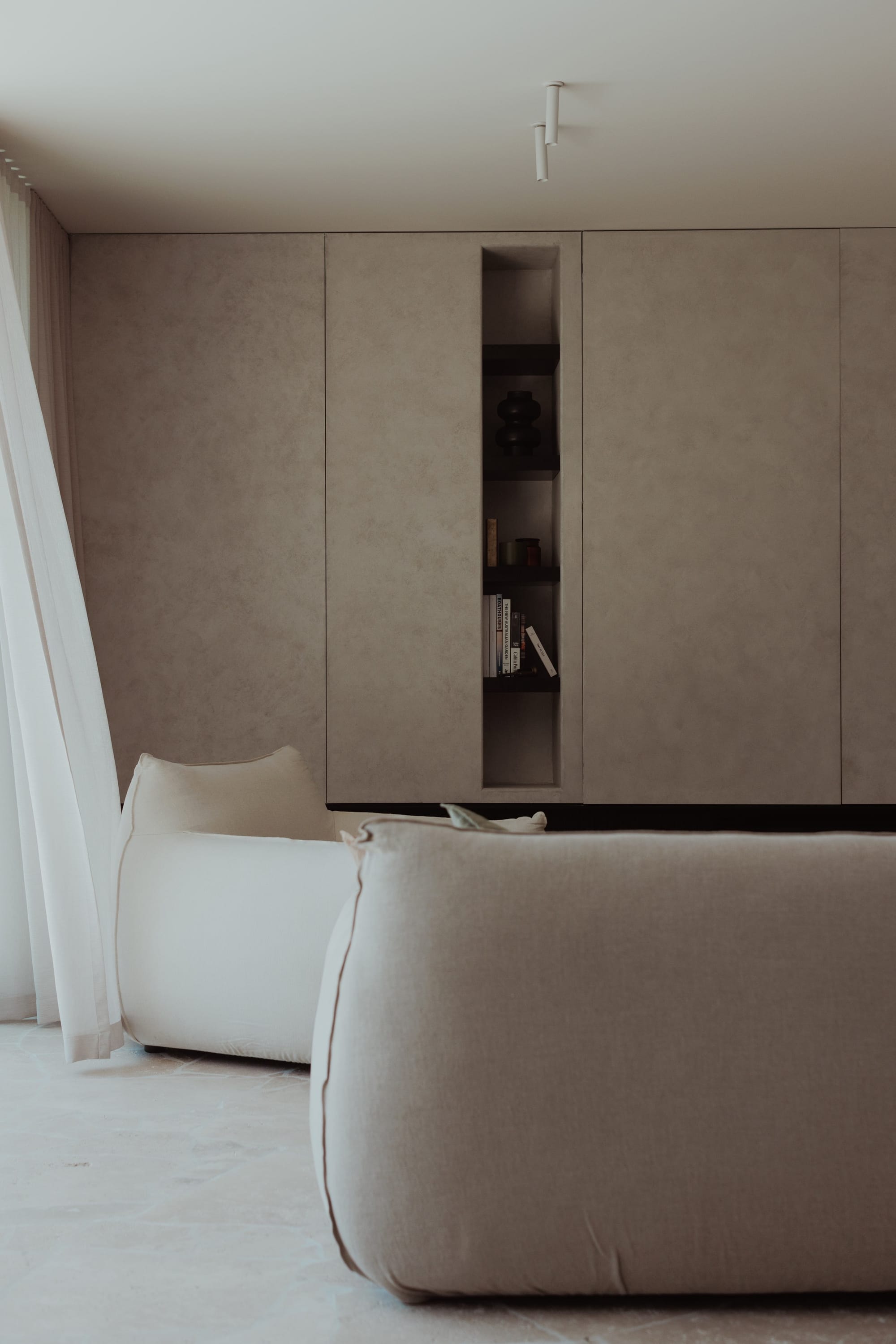 Little Birch by buck&simple. Photography by Tim Pascoe. Concrete tiered staircase in space with dark timber flooring and limewashed walls.