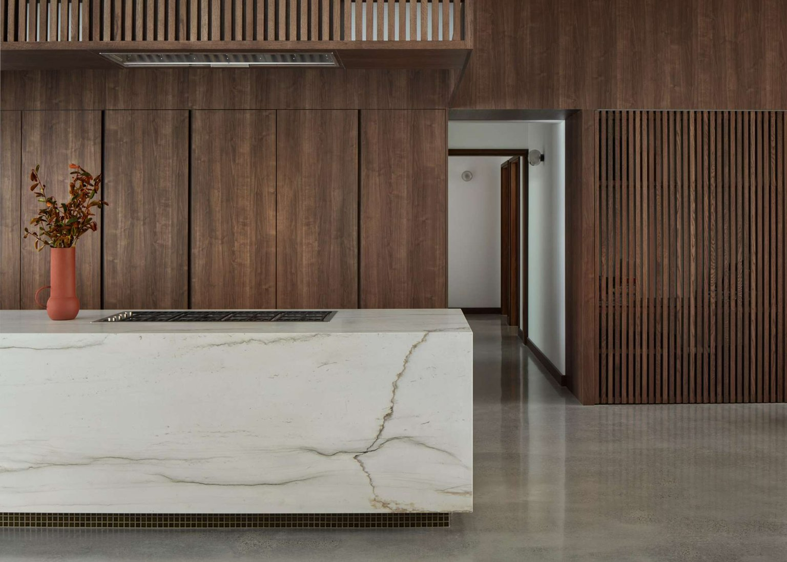 Chauncy Street by Keen Architecture. Phtography by Dion Robeson. Kitchen with green subway tiled wall and white stone island bench.