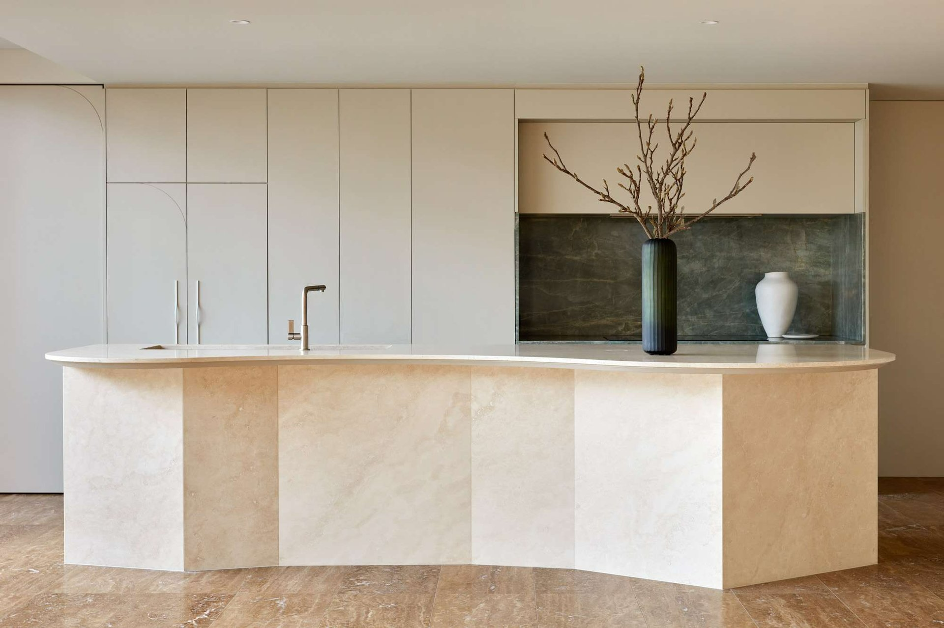 Sweep House by State of Kin. Photography by Jack Lovel. Angular and geometric island bench in light beige stone finish. 