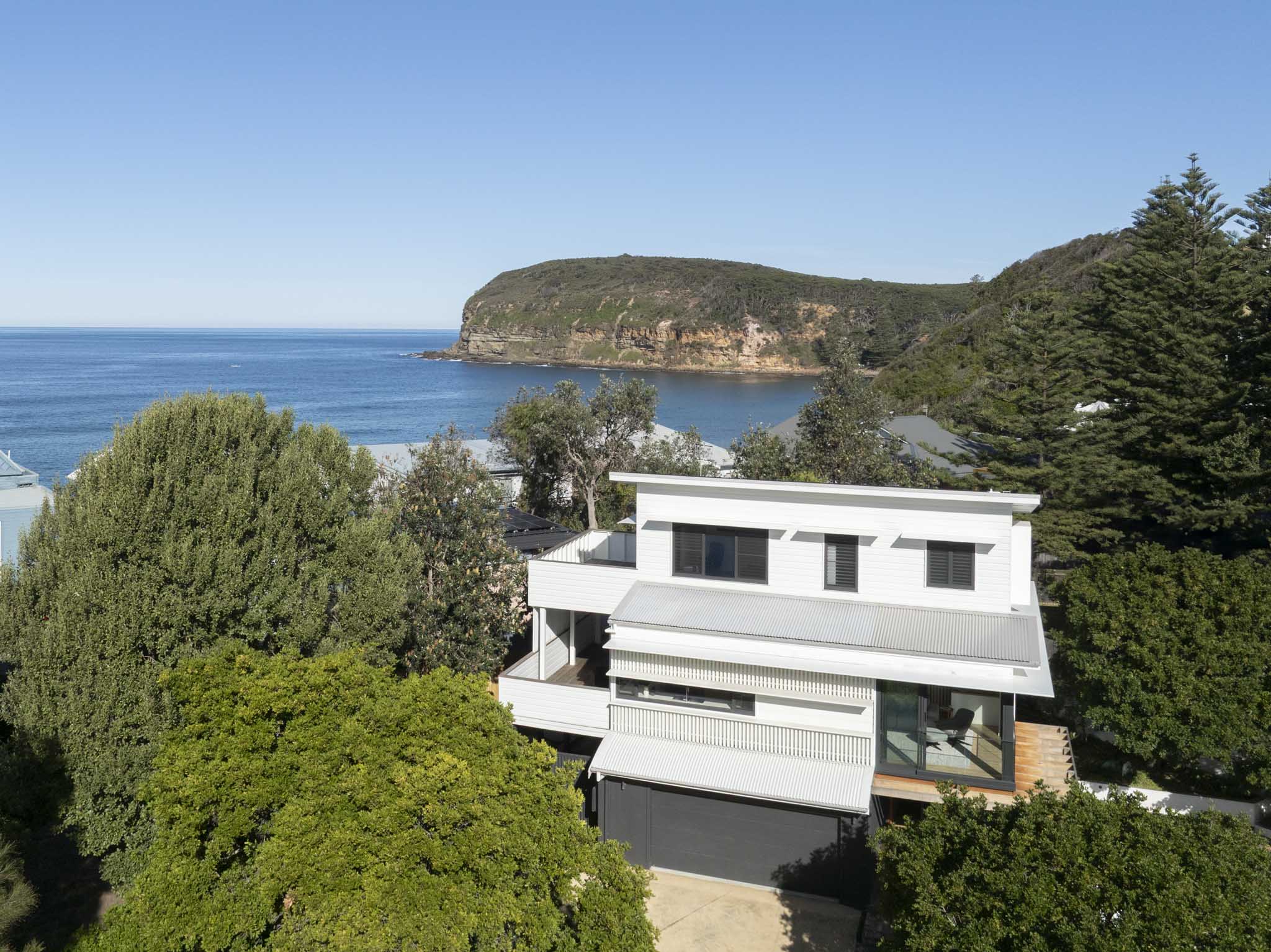 Three Points House by BIJL Architecture. Photography by Tom Ferguson. Twilight view of pool and garden terrace with warm interior lighting beyond.