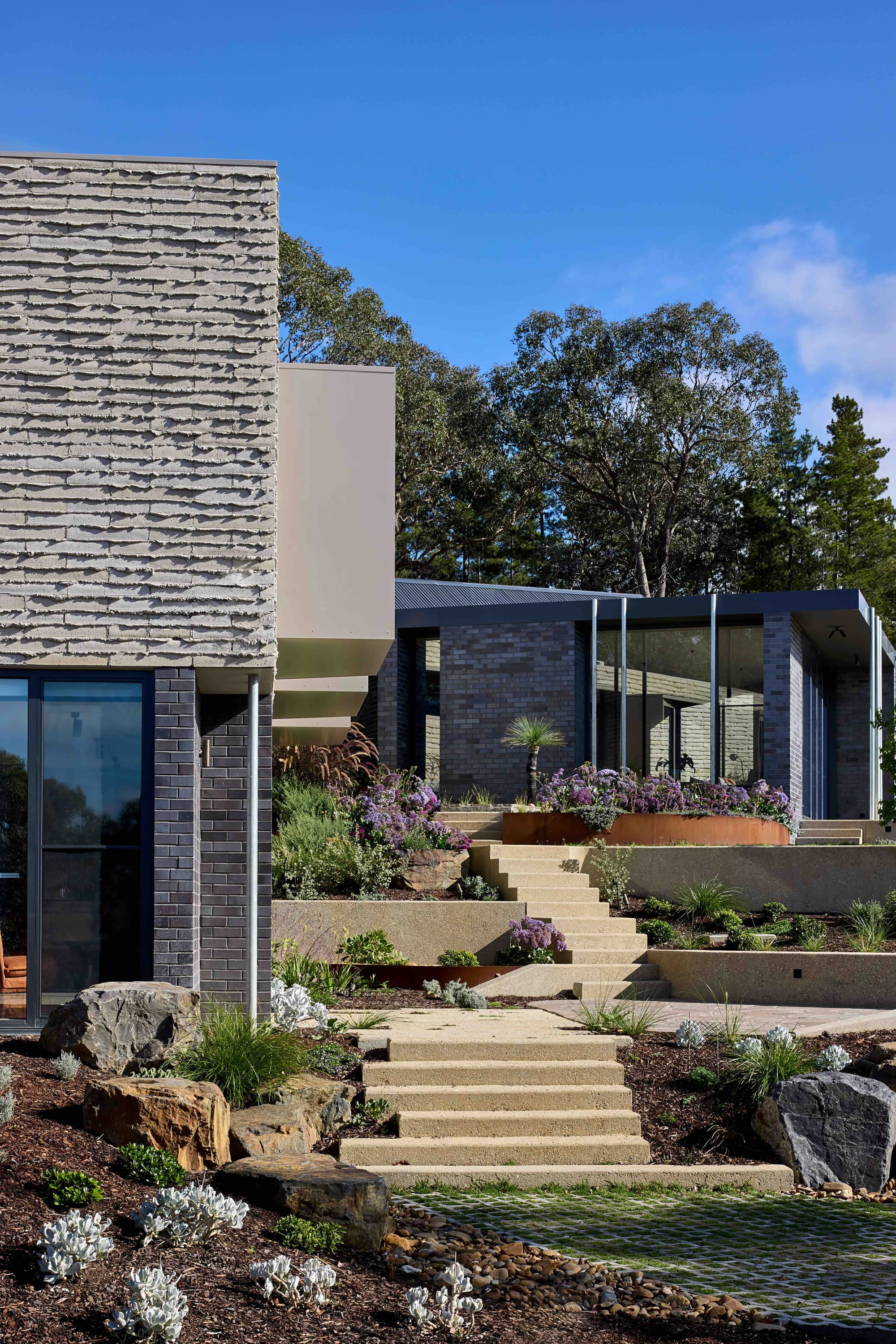 Korinda House by BENT Architecture. Photography by Tatjana Plitt. Tiered steps leading through garden. 