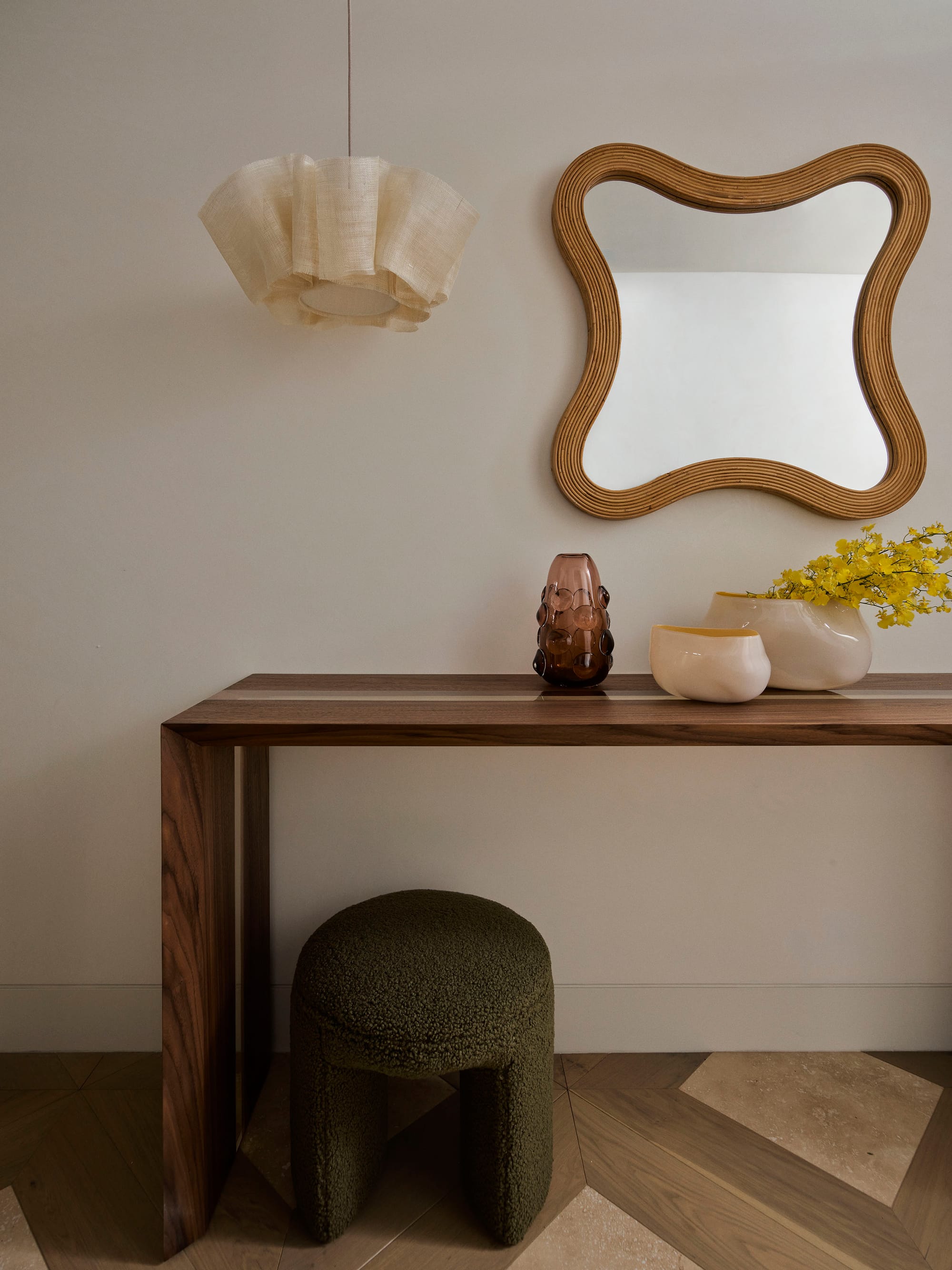 Bundarra Penthouse by Marylou Sobel Interior Design. Photography by Anson Smart. Hallway with parquet flooring, white walls and timber sideboard with olive boucle stool. 
