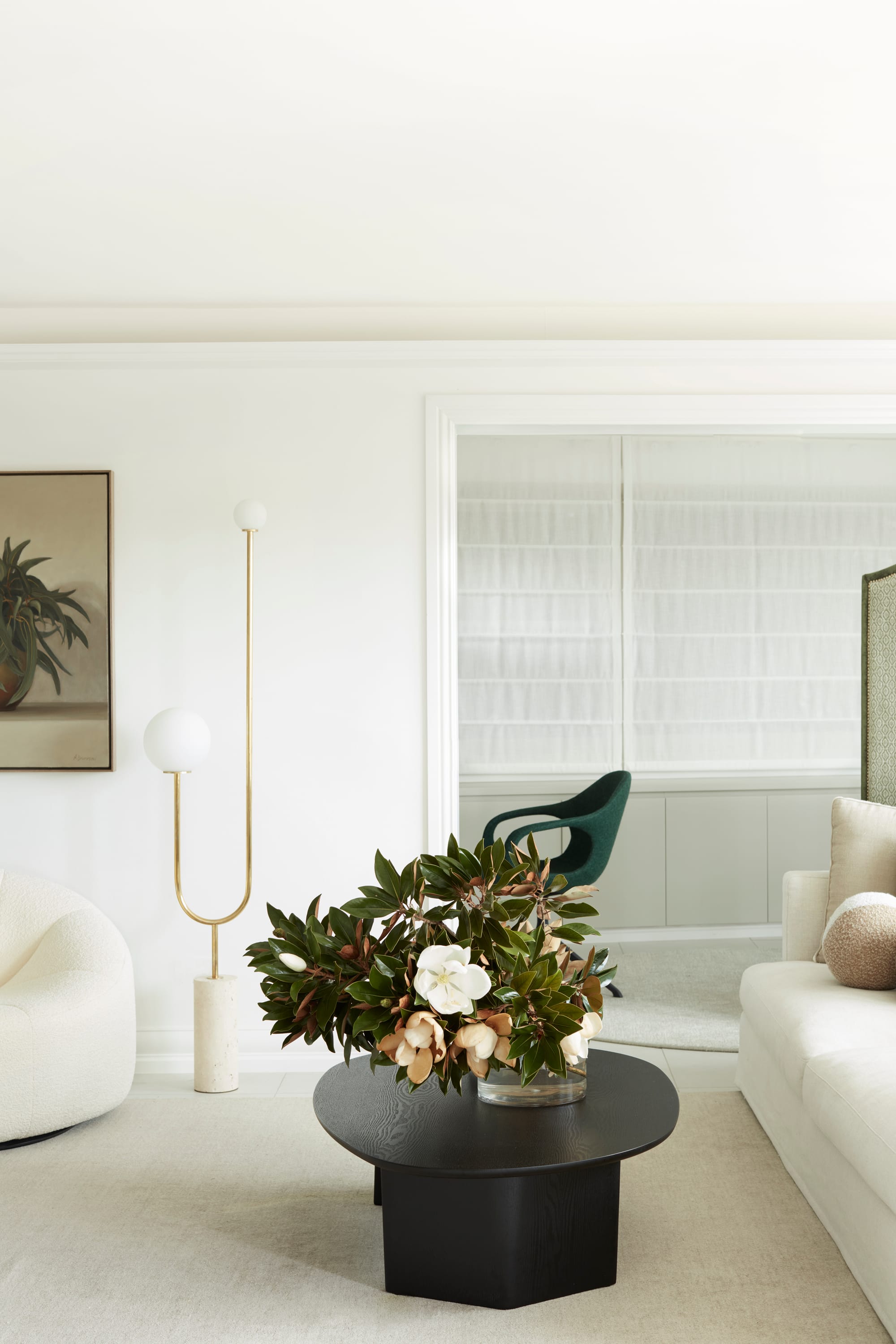 Marathon Road by Marylou Sobel Interior Design. Photography by Prue Ruscoe. Living room with black timber coffee table, white couches, carpet and walls. 