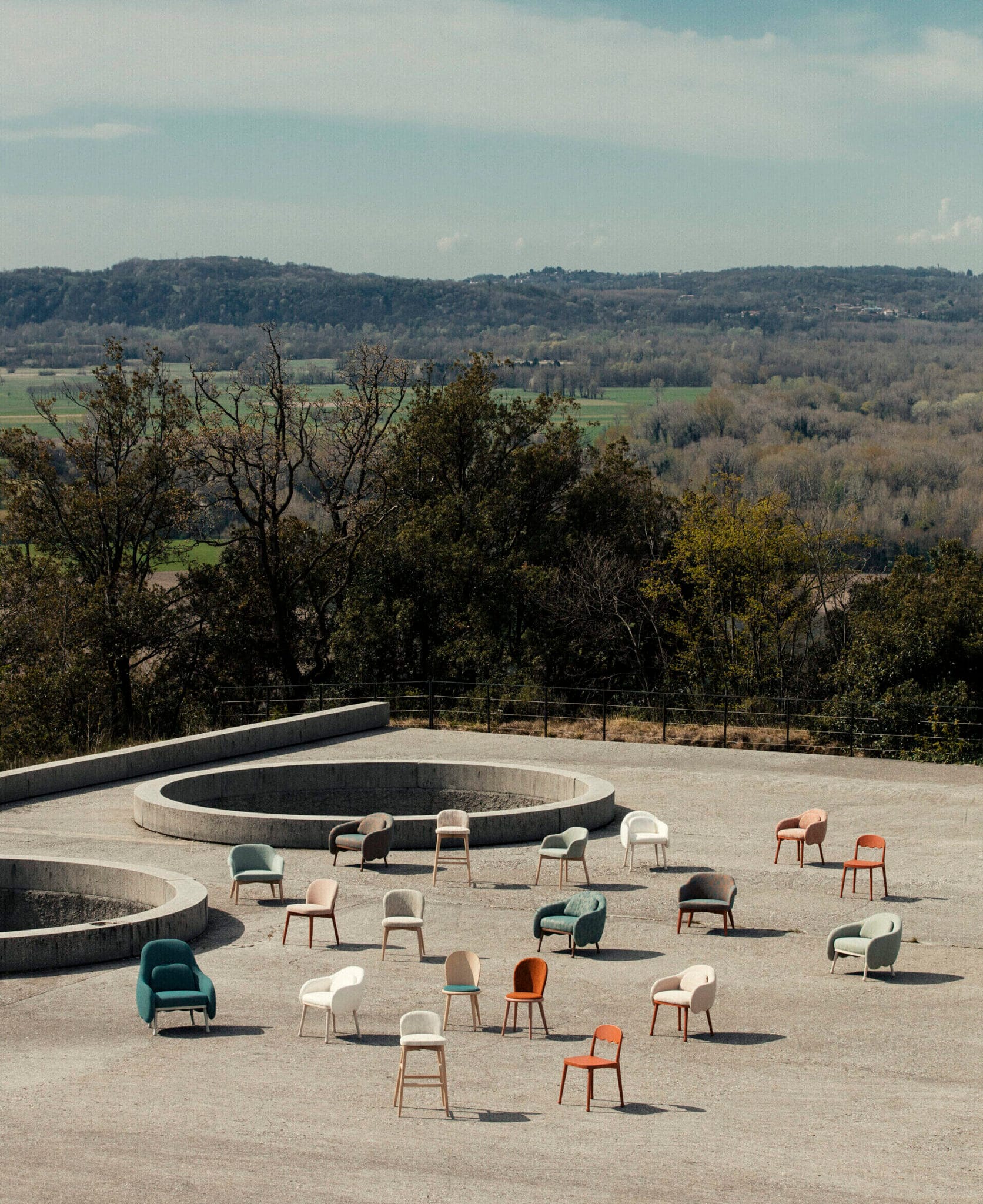 Billiani, Brand Partner for M&E Interiors. Various hairs and armchairs arranged on concrete rooftop with views over native bushland. 