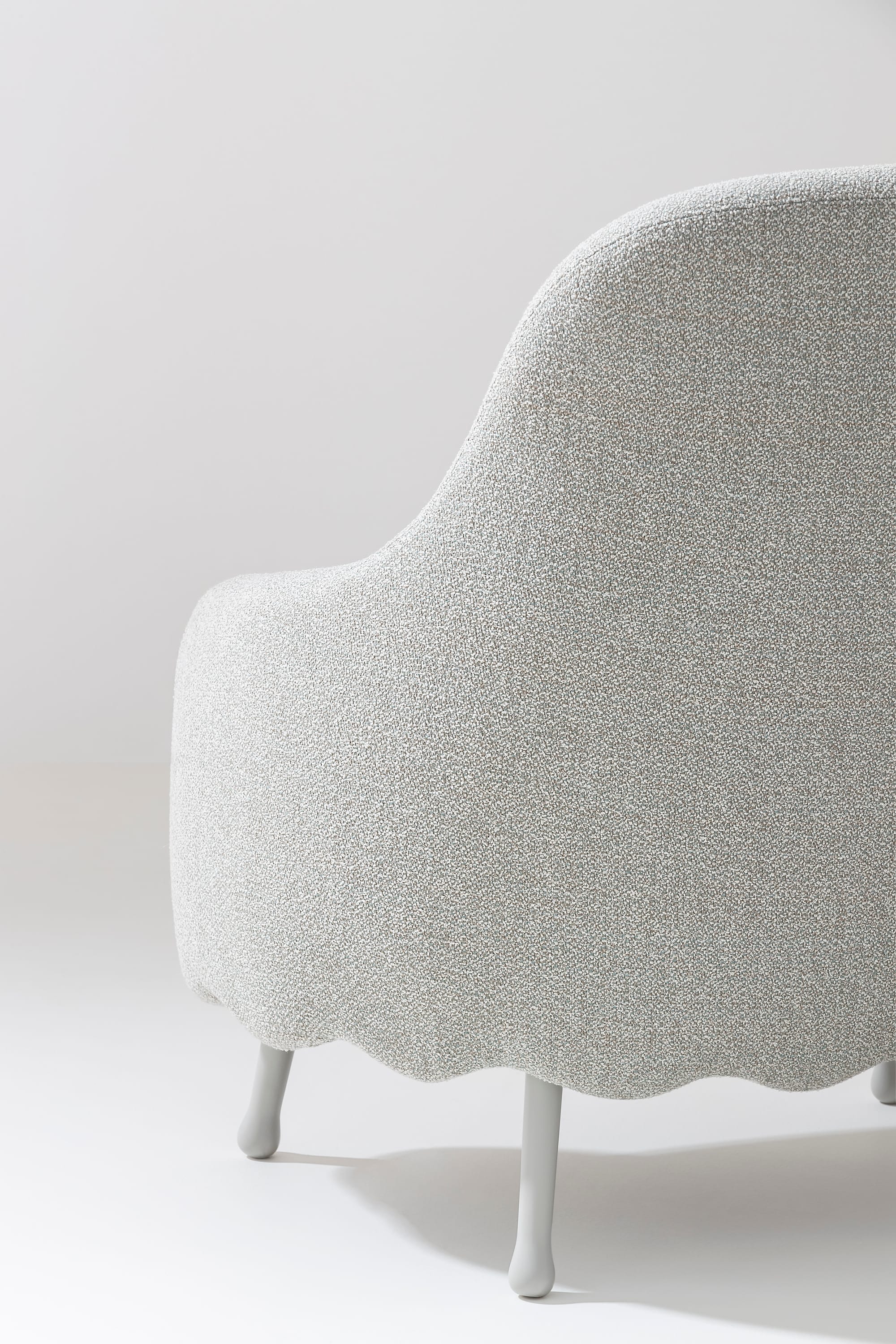 Billiani, Brand Partner for M&E Interiors. White boucle armchair with scalloped bottom edge. 