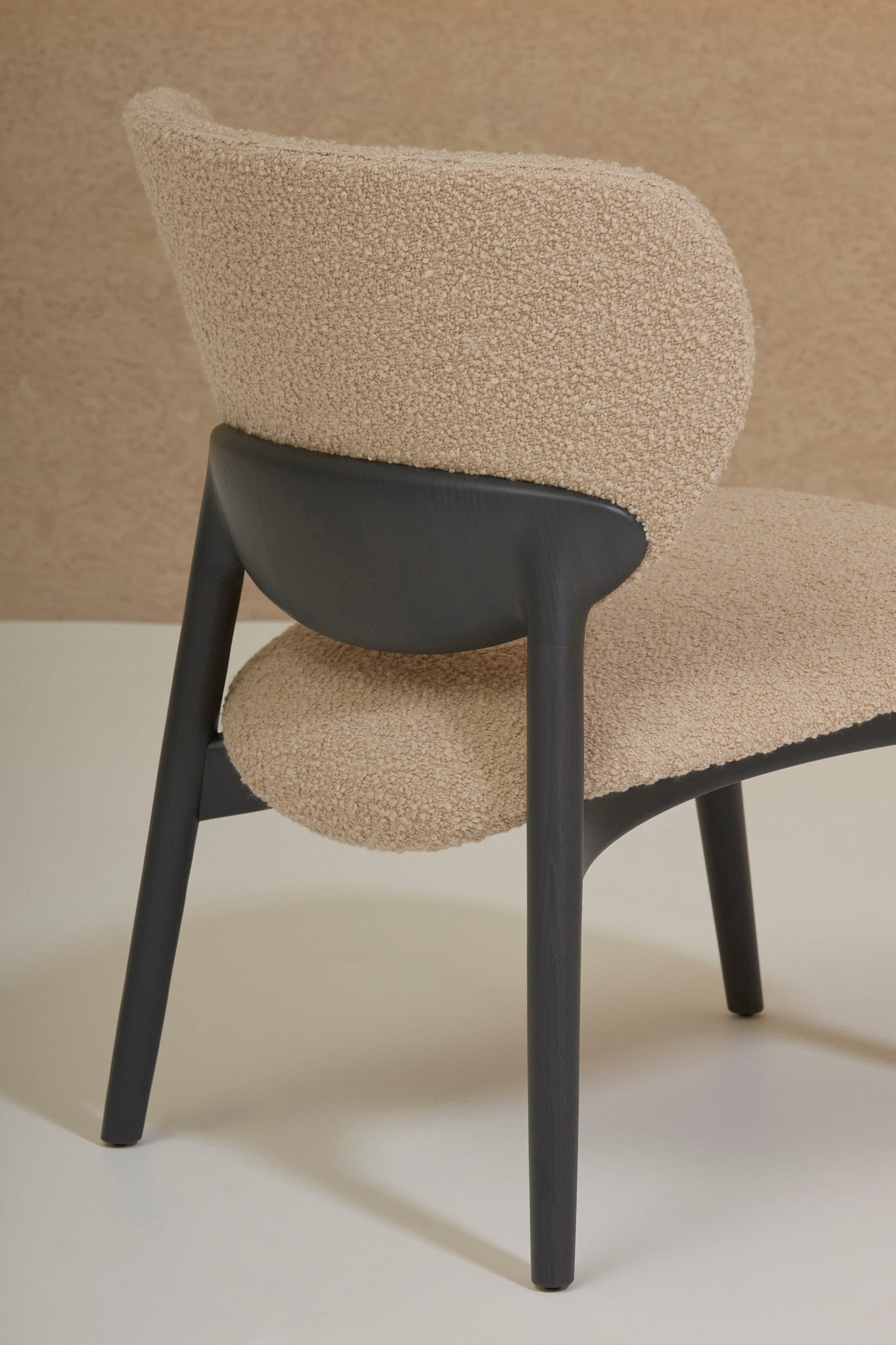 Billiani, Brand Partner for M&E Interiors. Black timber chair with beige boucle cushion and backrest. 