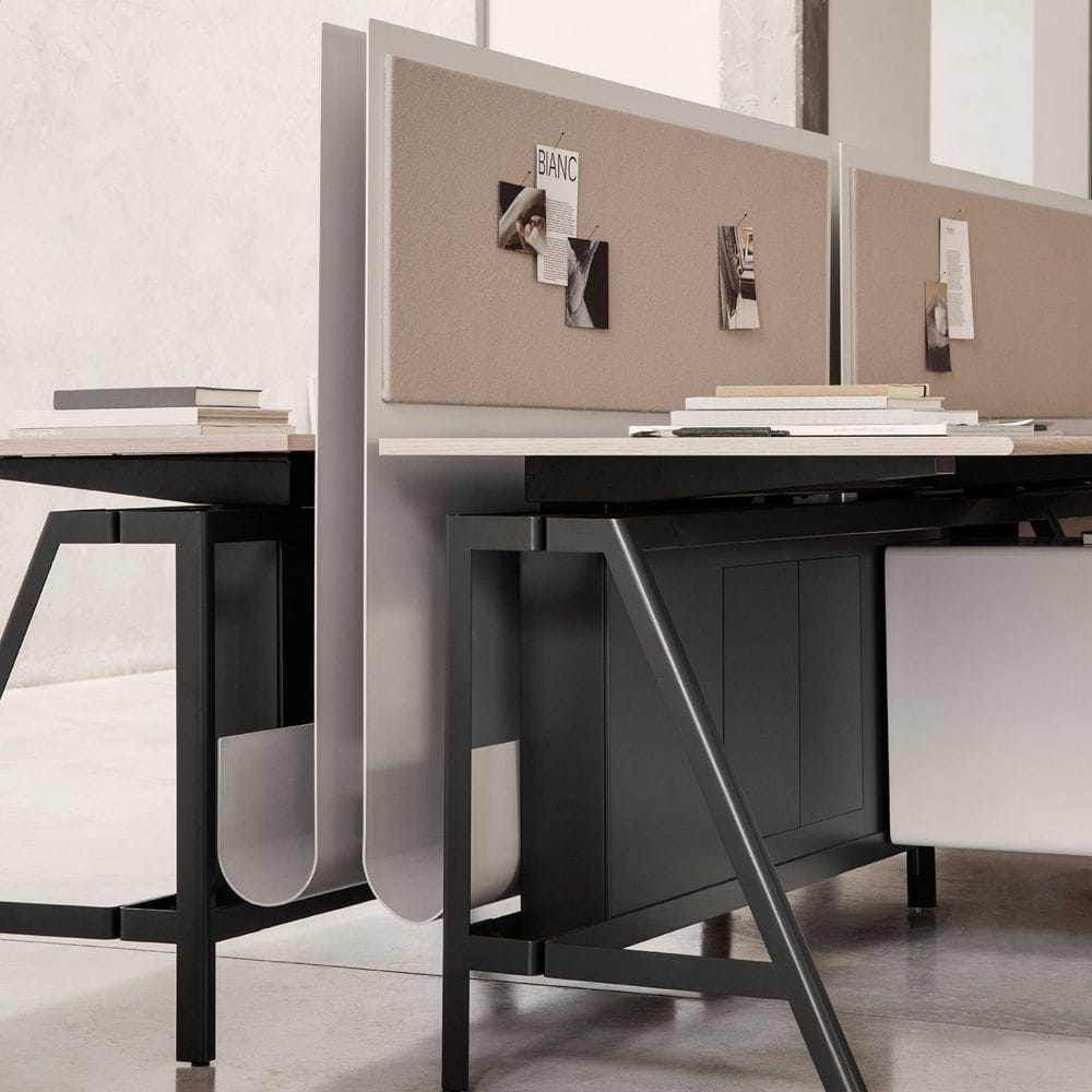 IOC Project Partners, Brand Partner for M&E Interiors. Close up of black and silver work desks with beige pinboards. 