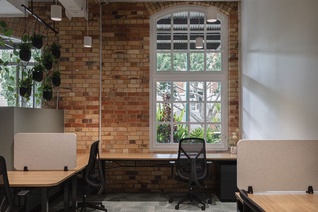 Billiani, Brand Partner for M&E Interiors. Various hairs and armchairs arranged on concrete rooftop with views over native bushland. 