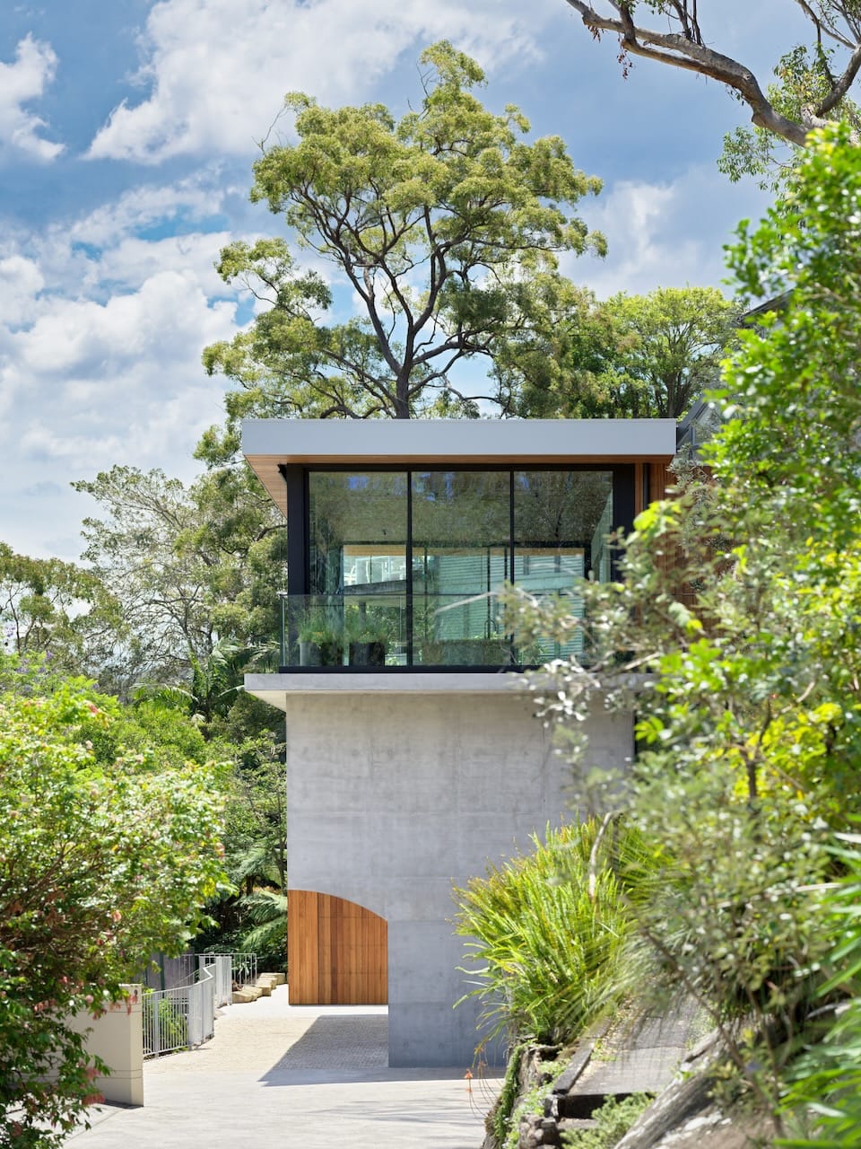 Corbel House by Nick Bell Architects. Photography by Justin Alexander. Double storey home with concrete ground floor and glass, windowed upper floor. 