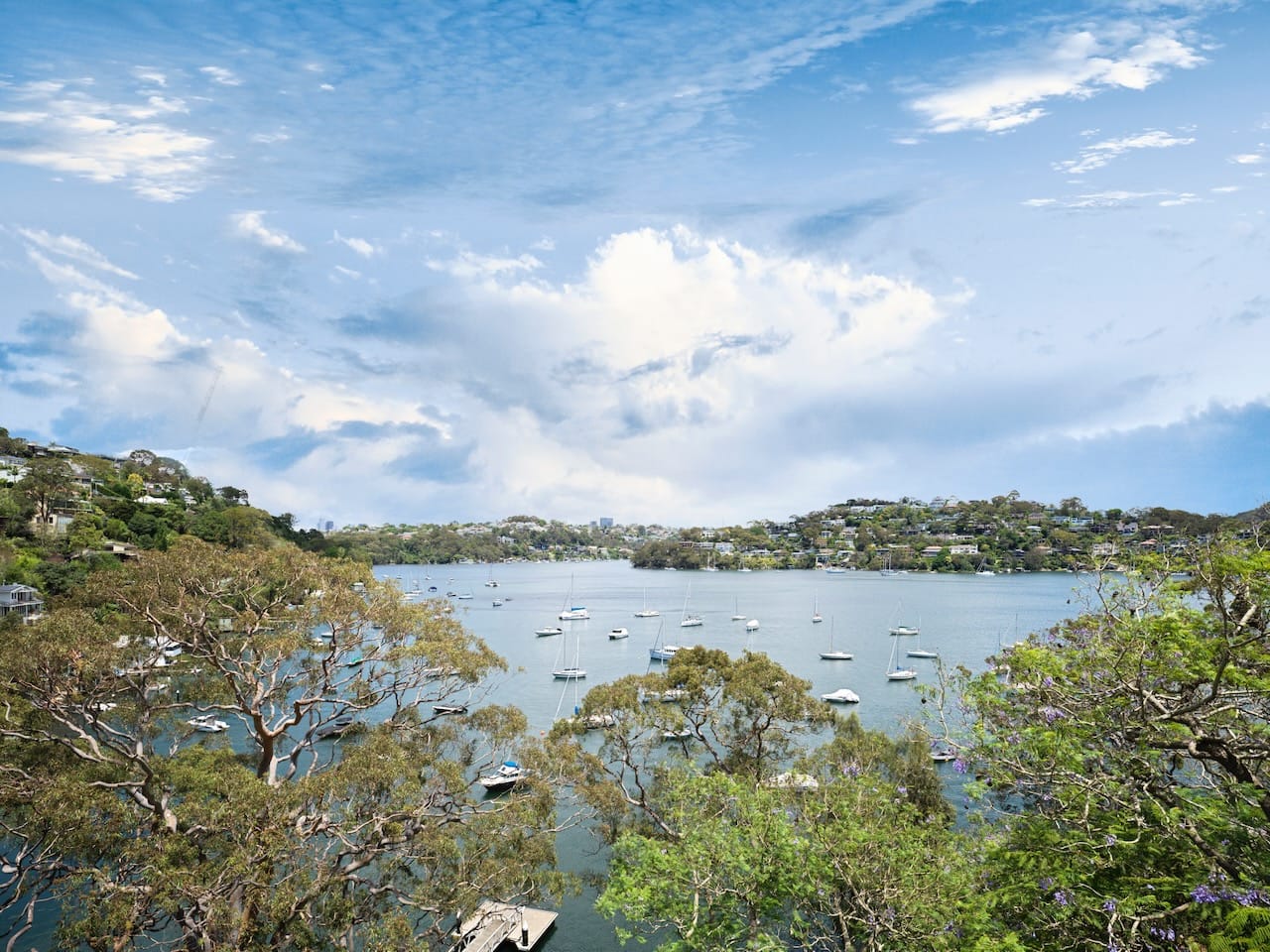 Corbel House by Nick Bell Architects. Photography by Justin Alexander. Panormaic views over harbour, with multiple yachts, and hillside. 