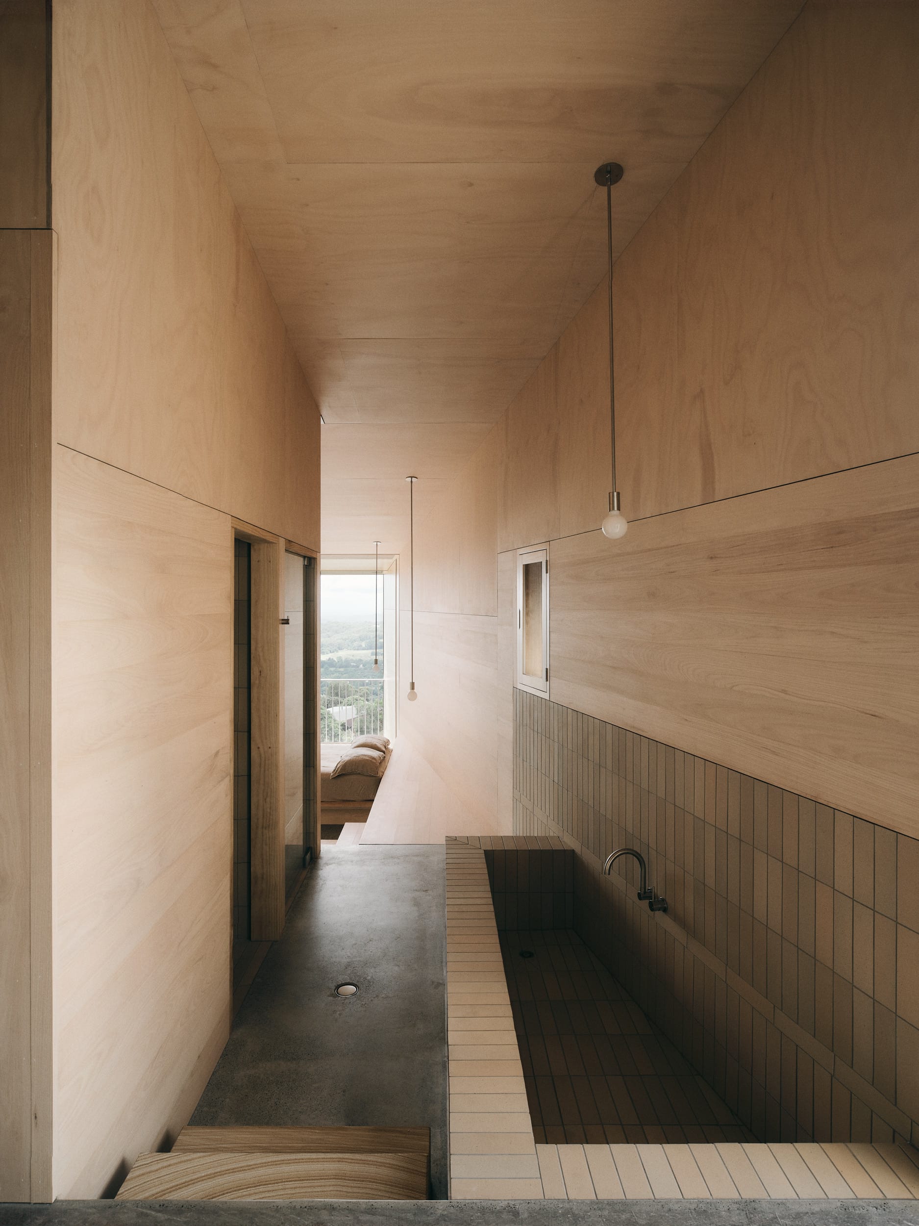 Mapleton House by Atelier Chen Hung. Photography by David Chatfield. Brick sink in hallway with concrete floors, timber walls and ceilings. 