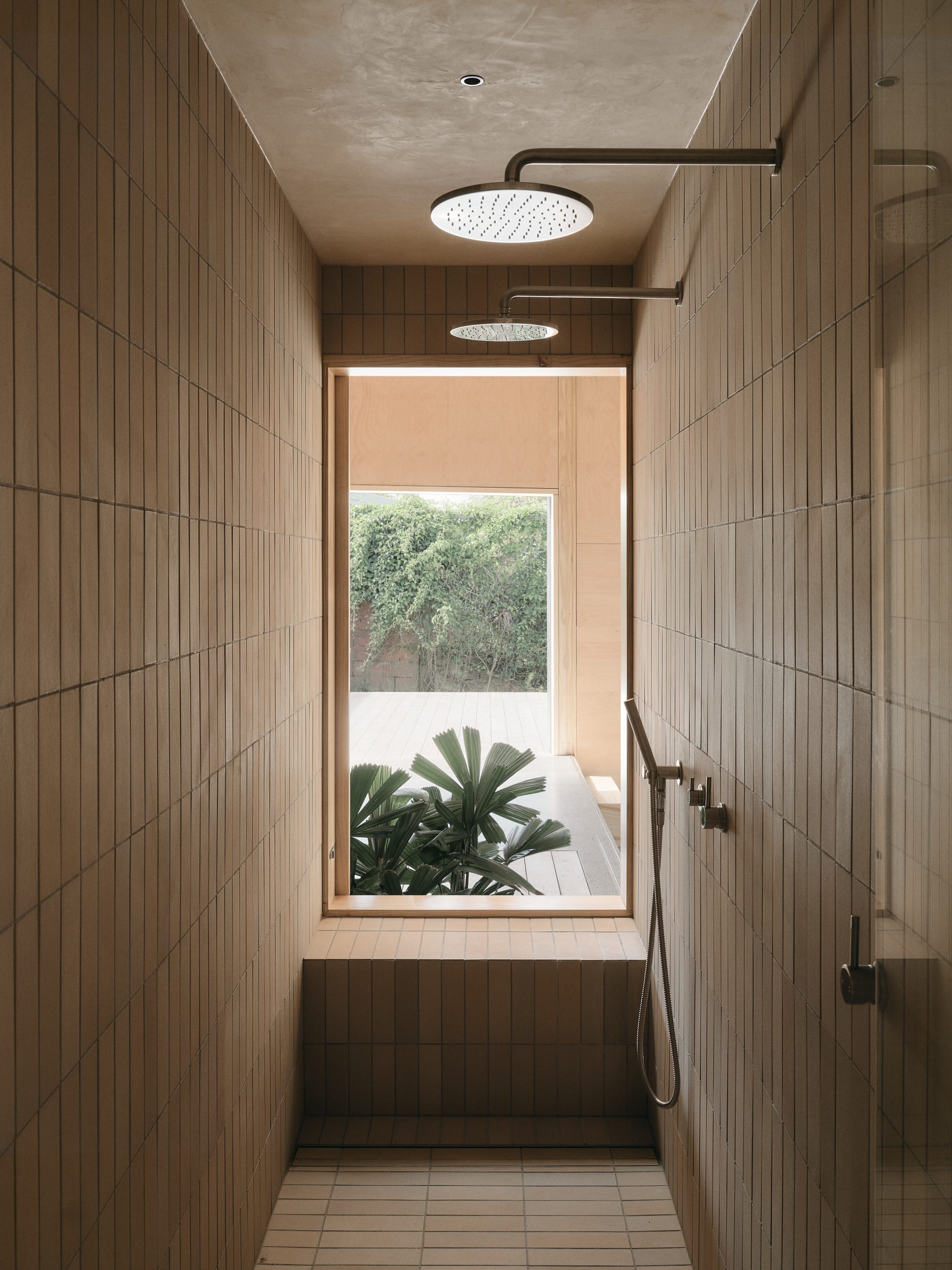 Mapleton House by Atelier Chen Hung. Photography by David Chatfield. Shower with brick floors, walls and window seat, overlooking deck and garden. 