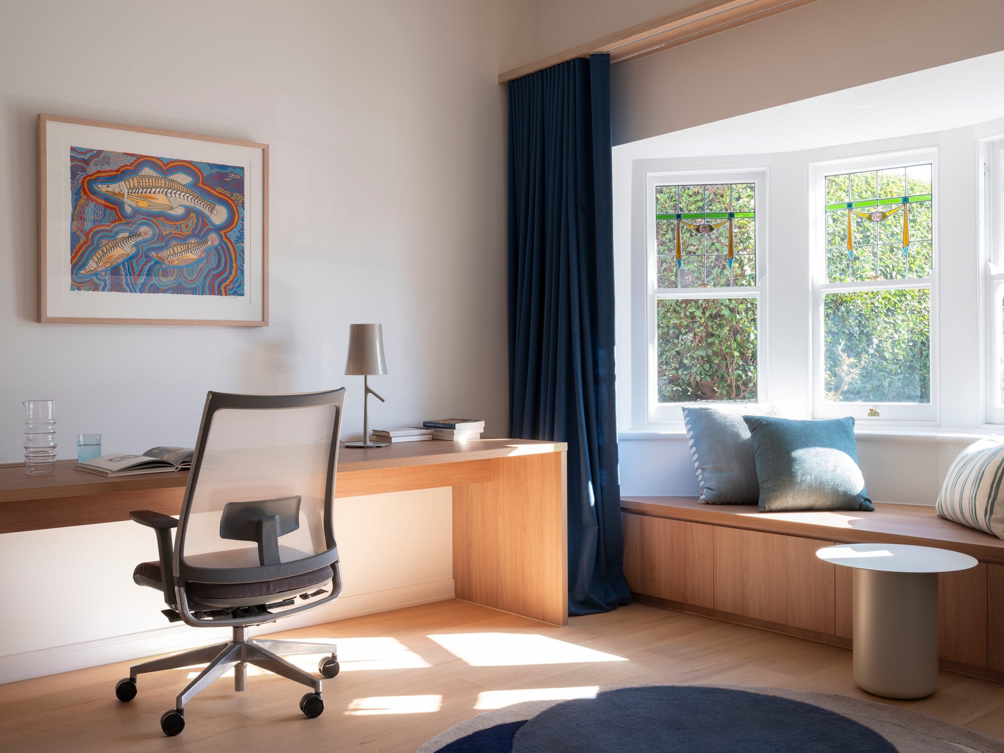 Merrilands by BIJL Architecture. Photography by Tom Ferguson. Office space with timber desk, flooring and bench seat, navy curtains and rug and white walls.