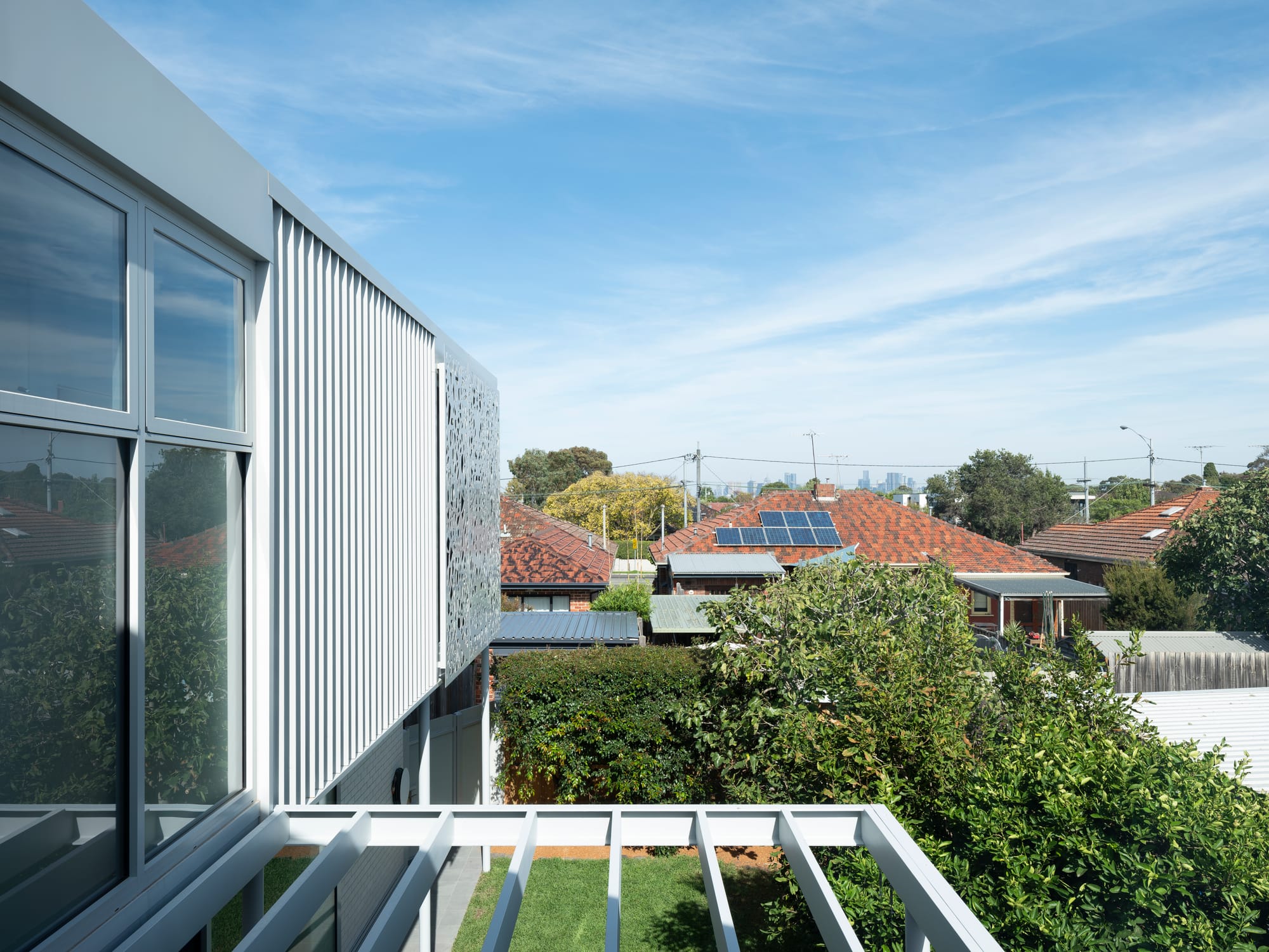 Merrilands by BIJL Architecture. Photography by Tom Ferguson. View over outdoor pergola, grassy backyard and neighbourhood from second storey of residential home.