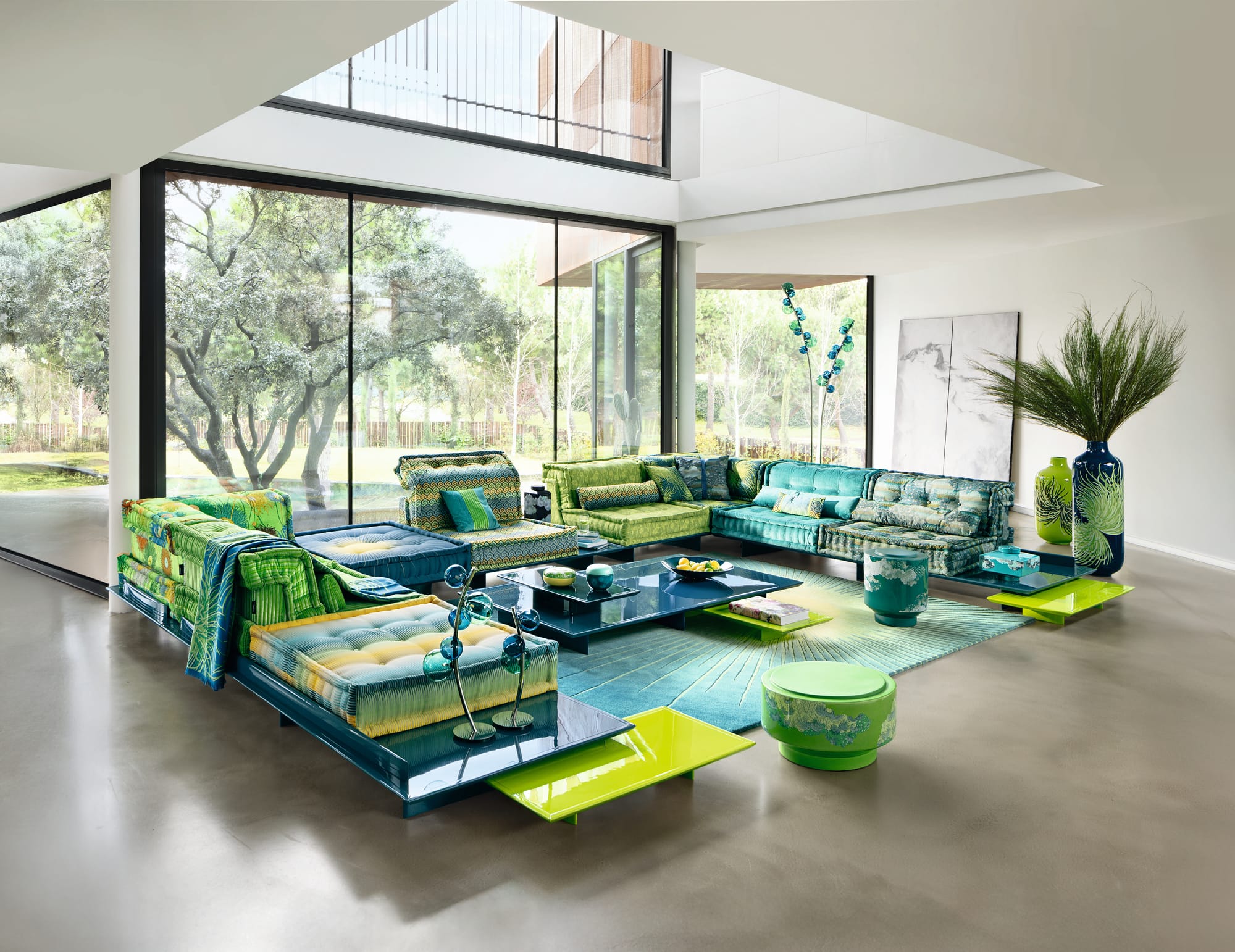 Mah Jong by Roche Bobois. Image copyright of Roche Bobois. Modular couch on glossy green and teal platform, with teal gloss coffee table and rug. 