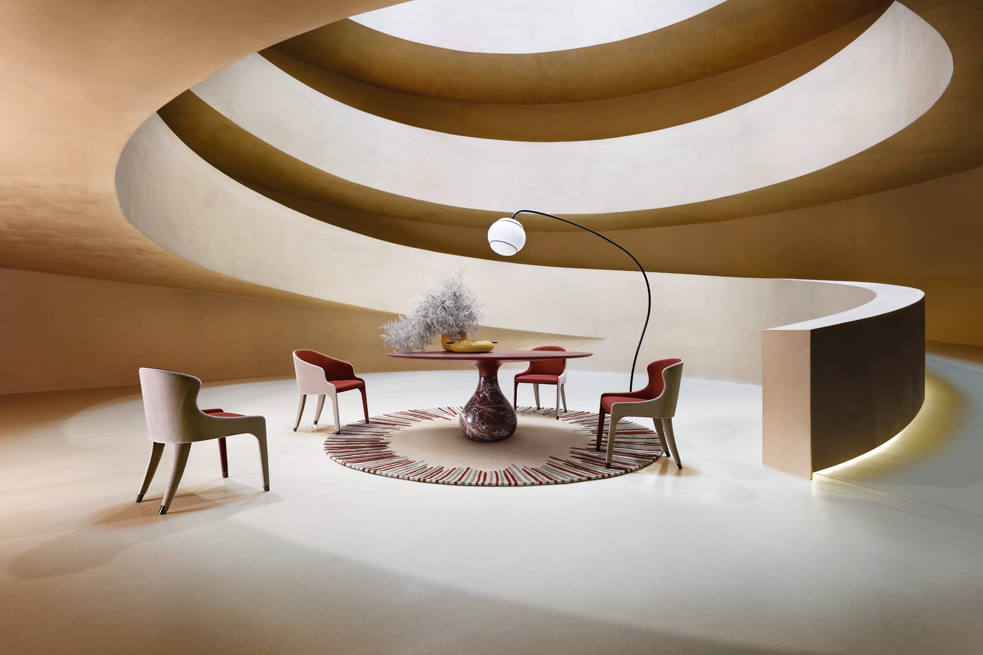 The Aqua Table by Roche Bobois. Image copyright of Roche Bobois. Round black and marble dining table on round black and white rug with black chairs. 