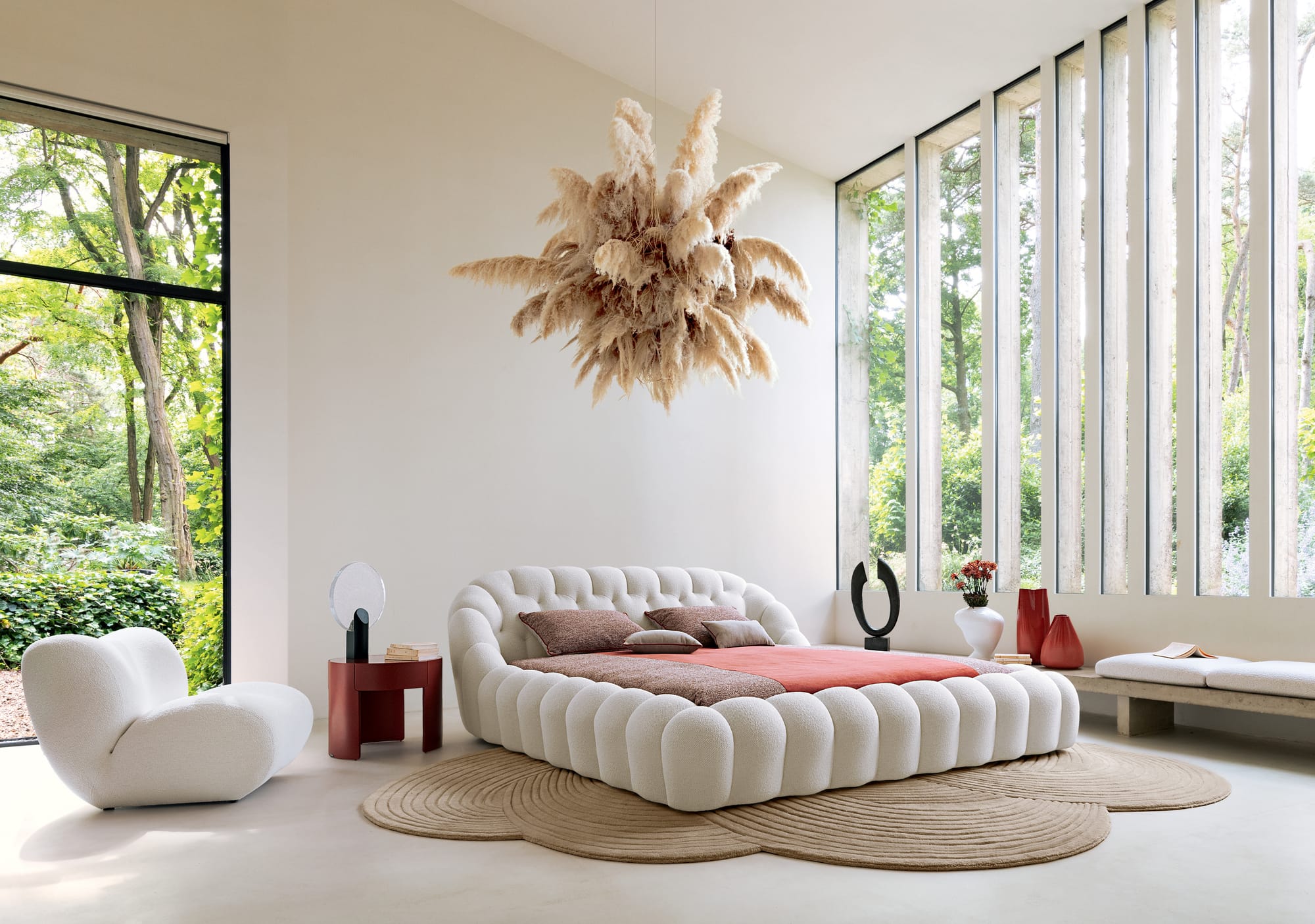 Bubble Collection by Roche Bobois. Image copyright of Roche Bobois. White bubble bed in space with white floors, beige floor rug, large beige floral ceiling pendant and pink bedding. 