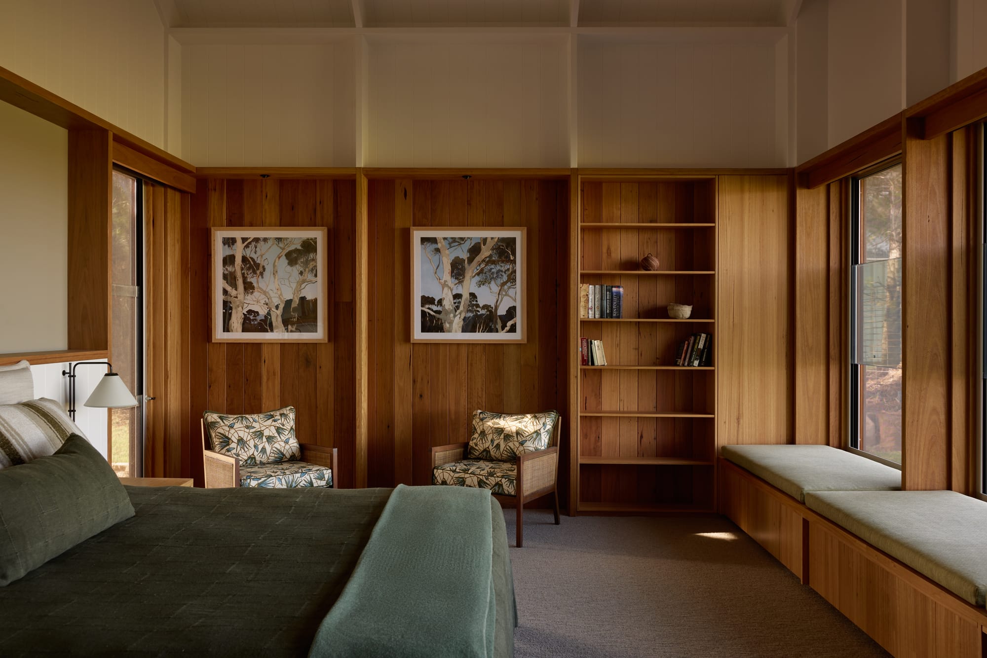 Binnum Homestead by Alexandra Buchanan Architecture. Photography by Cieran Murphy. Bedroom with timber clad walls, green bedspread and built-in window seating. 