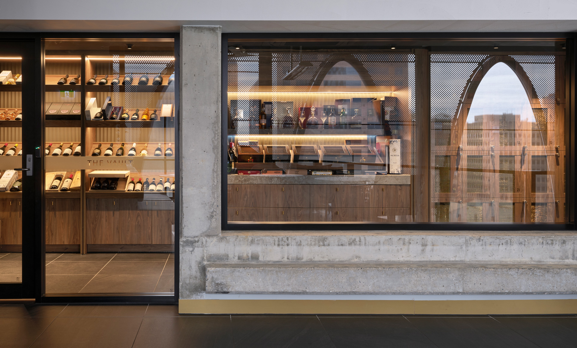 SORA Rooftop by PACT Architects. Photography by Sam Noonan. Glass and concrete facade on wine store with warm interior lighting and dark tile floors. 